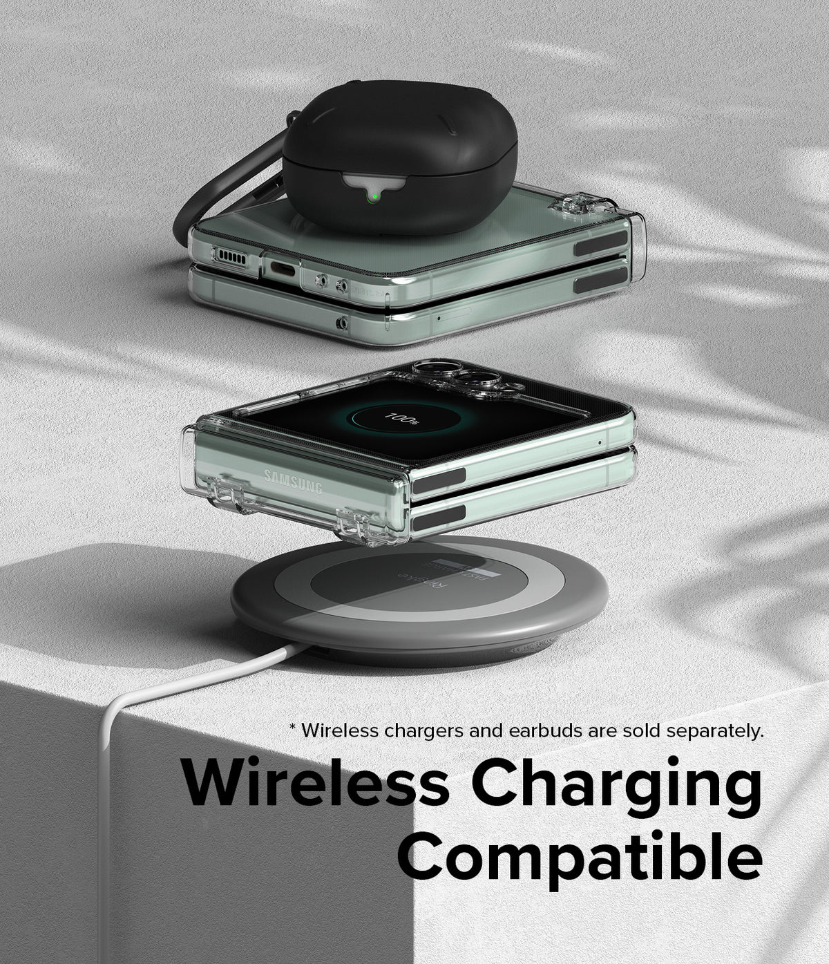 Galaxy Z Flip 5 Case | Slim Hinge - Clear - Folded phone in clear case wirelessly charging with earbuds on top.