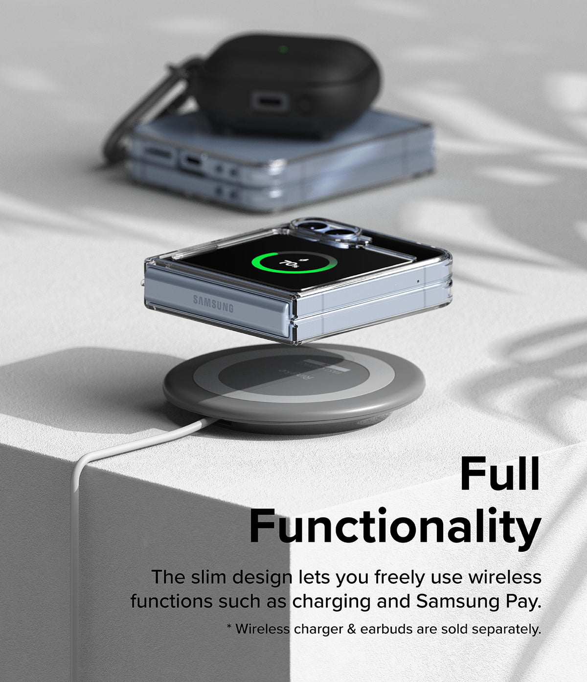 Galaxy Z Flip 7 FE Case | Fusion - Folded phone in clear case wirelessly charging on a pad with earbuds in background.