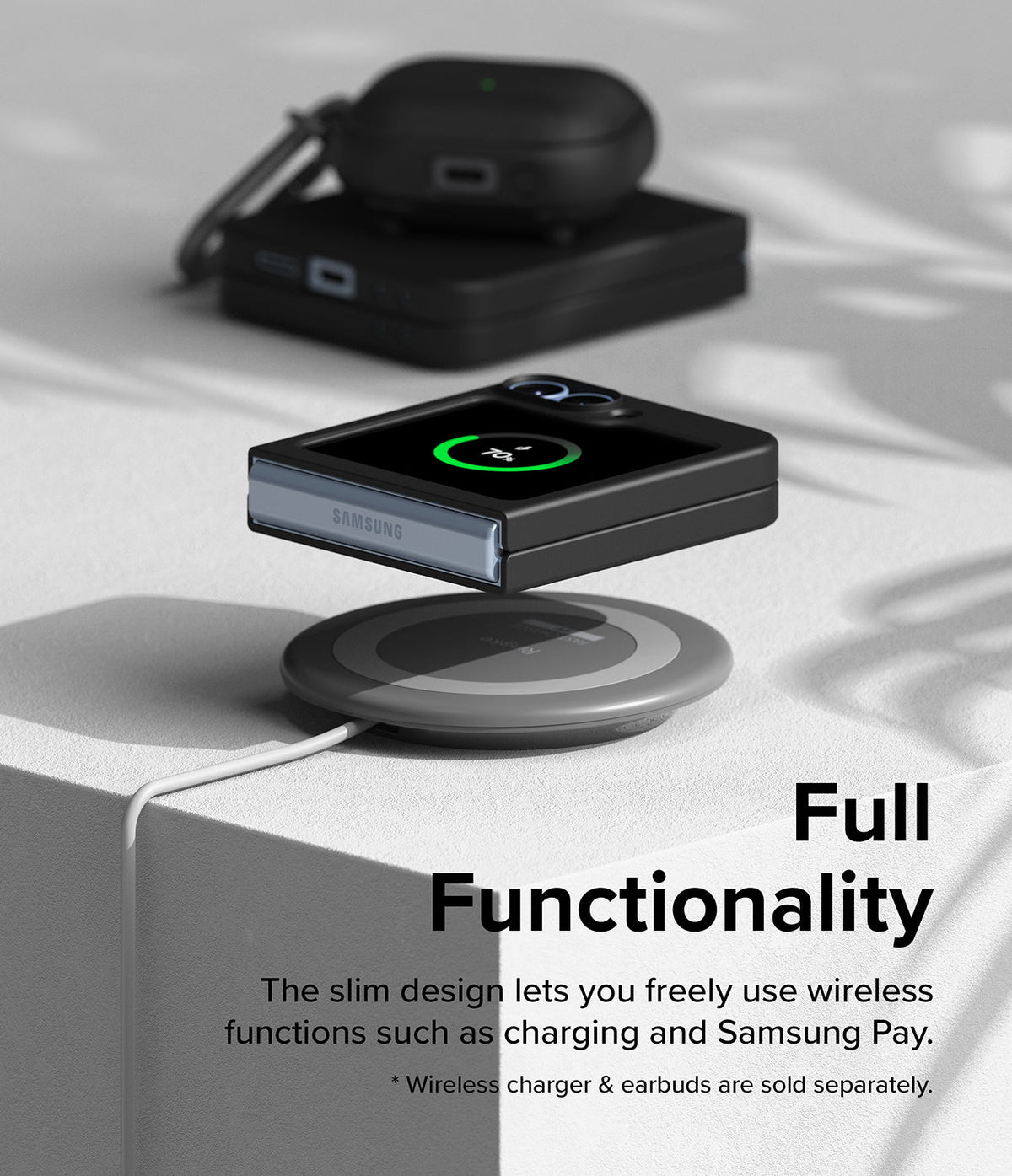 Galaxy Z Flip 7 FE Case | Slim - Folded phone in a slim black case wirelessly charging on a pad with earbuds nearby.