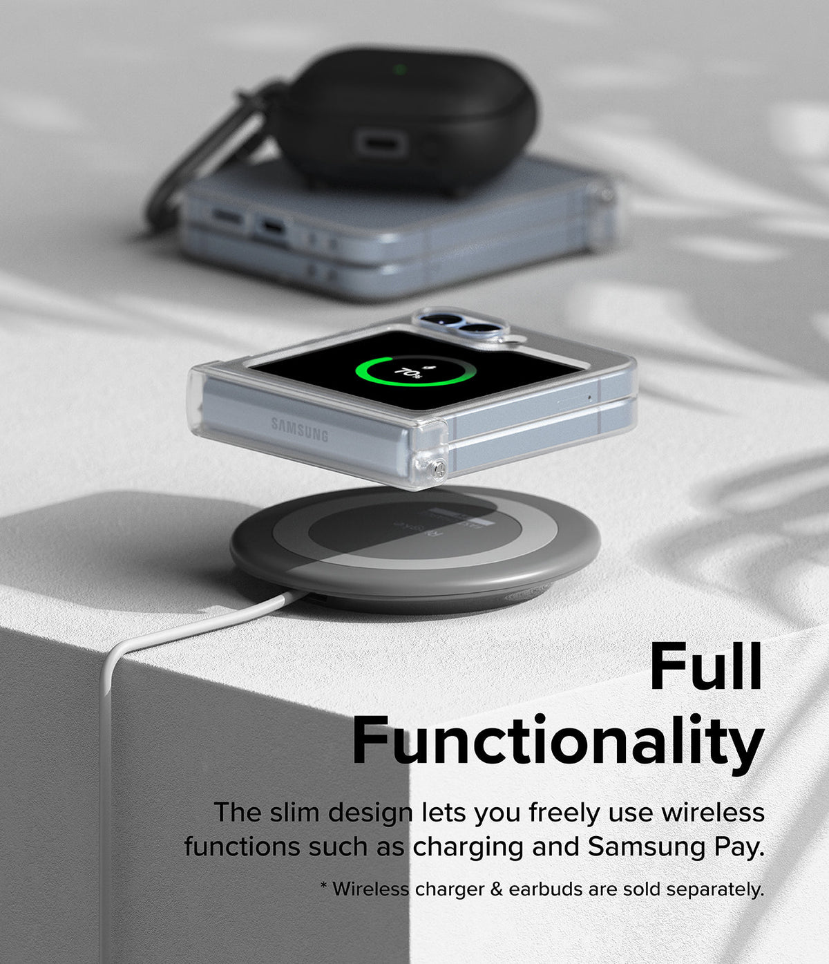 Galaxy Z Flip 7 FE Case | Slim Hinge - A folded phone in a clear case wirelessly charging on a pad with earbuds nearby.