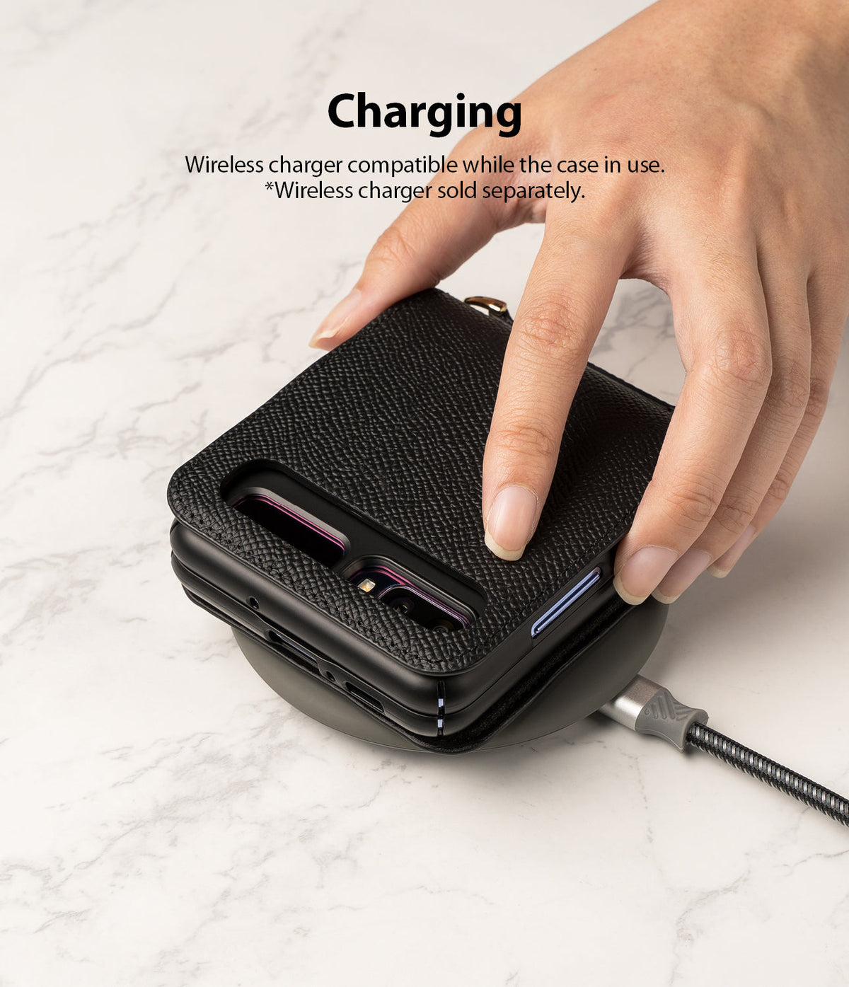 Galaxy Z Flip Case | Folio Signature Black - A hand places a black leather Galaxy Z Flip case onto a wireless charger.