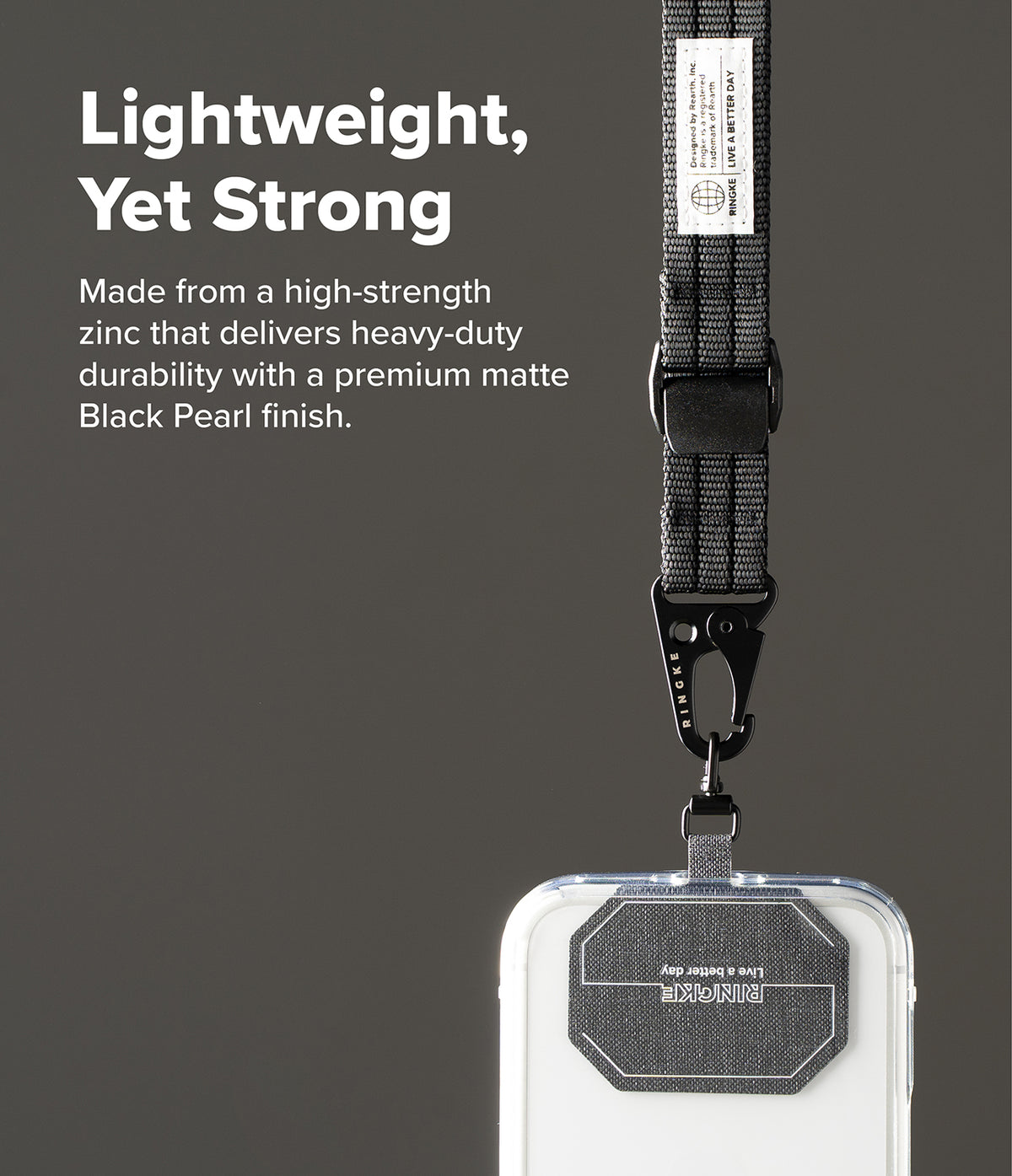 Holder Link Tactical Cam Buckle Hand Strap - A close-up of a black phone lanyard with a matte black pearl finish and a metal clasp, attached to a clear phone case. The background is a solid dark gray with white text describing the product's lightweight and strong qualities.