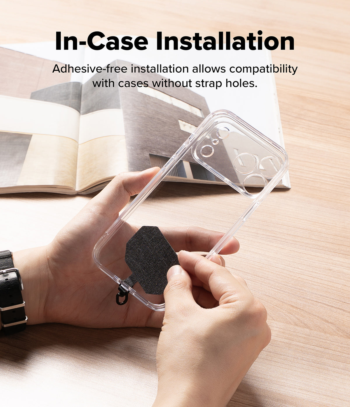 Holder Link Tactical Cam Buckle Hand Strap - Person holding a clear phone case with adhesive-free installation feature on a wooden surface.