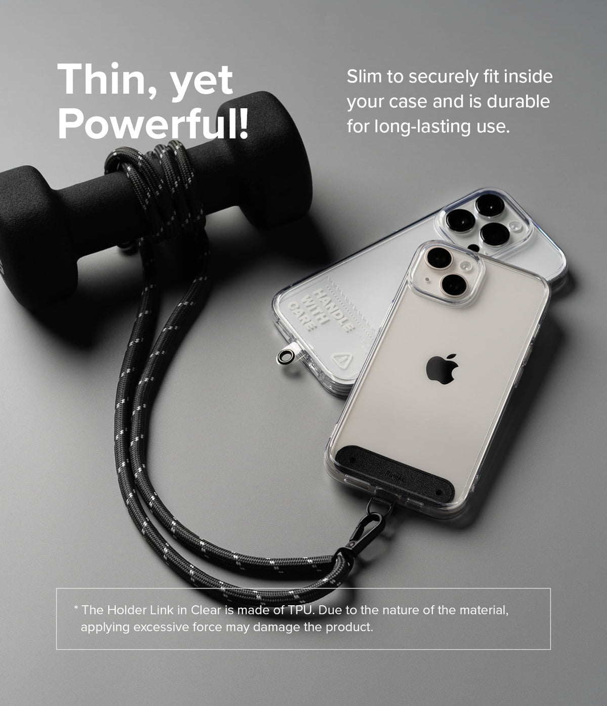 Holder Link Strap | Clear - Black rope strap attached to a clear phone case, resting next to a dumbbell on a gray surface.