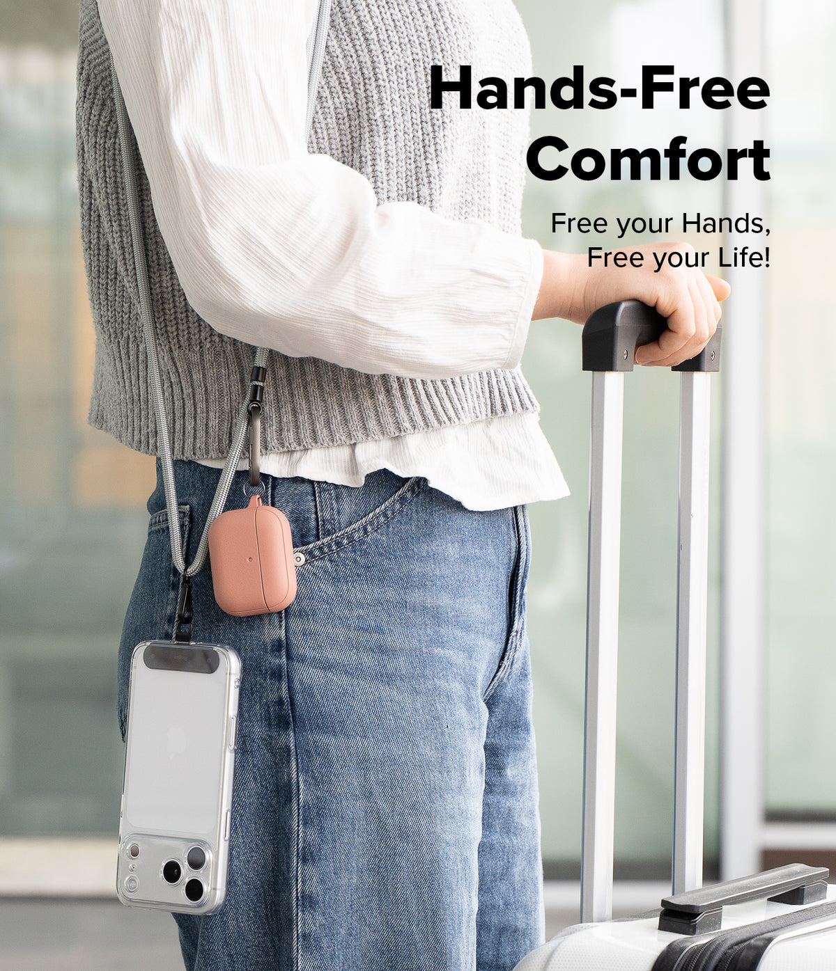 Holder Link Strap | Black - Person wearing a crossbody strap holding a phone and pink earbud case while pulling luggage.