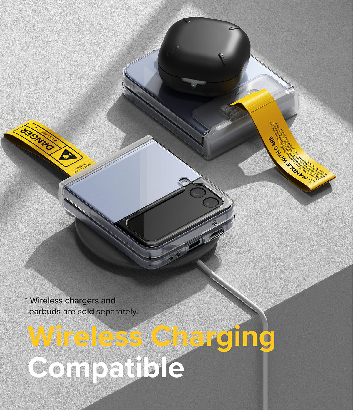 Galaxy Z Flip 7 FE / 6 / 5 / 4 / 3 | Hinge Cover Tarpaulin - Folded phones with yellow warning straps on a wireless charger.