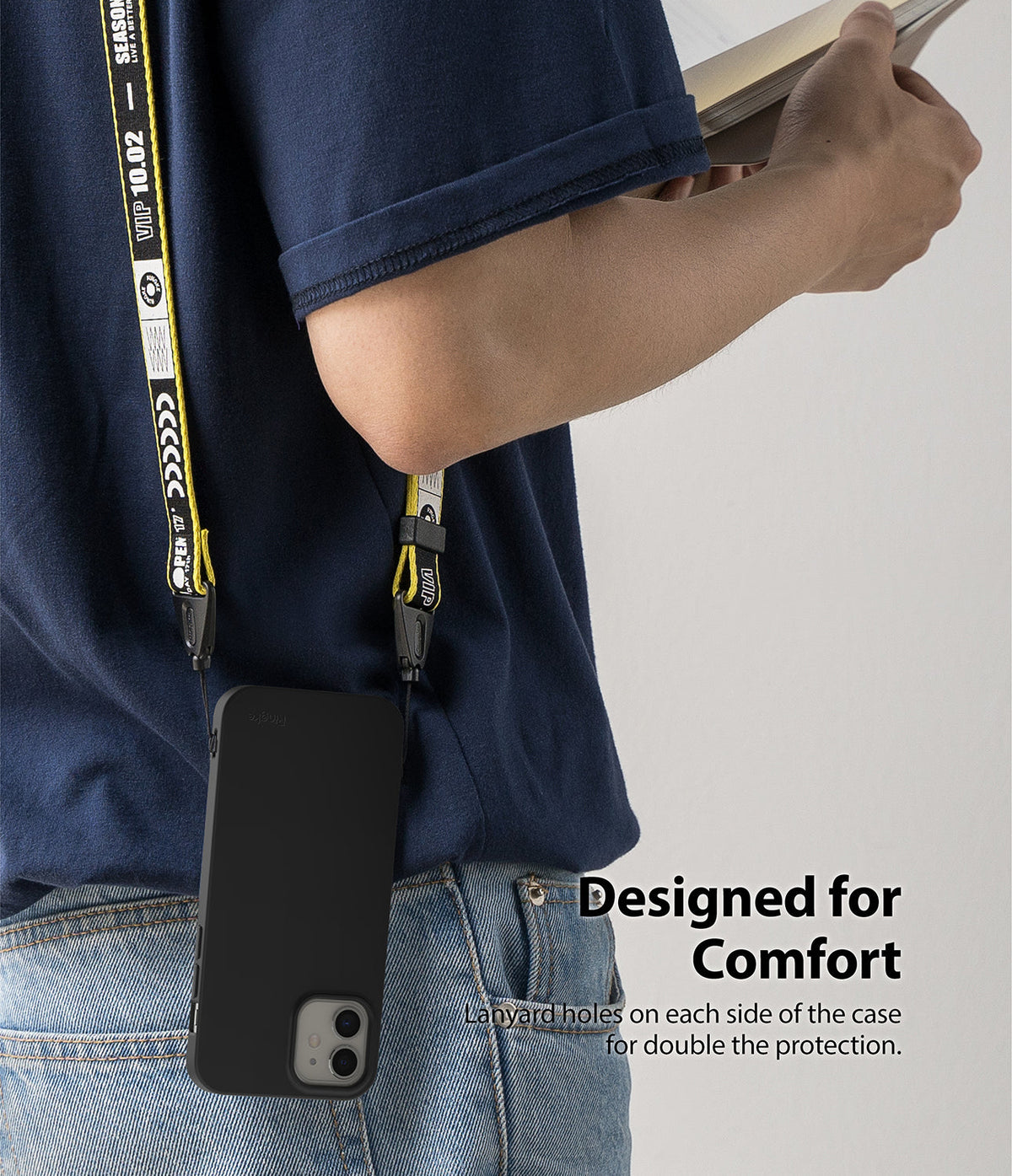 iPhone 12 Mini Case | Air-S - Black phone case hanging from a yellow and black branded lanyard worn over the shoulder.