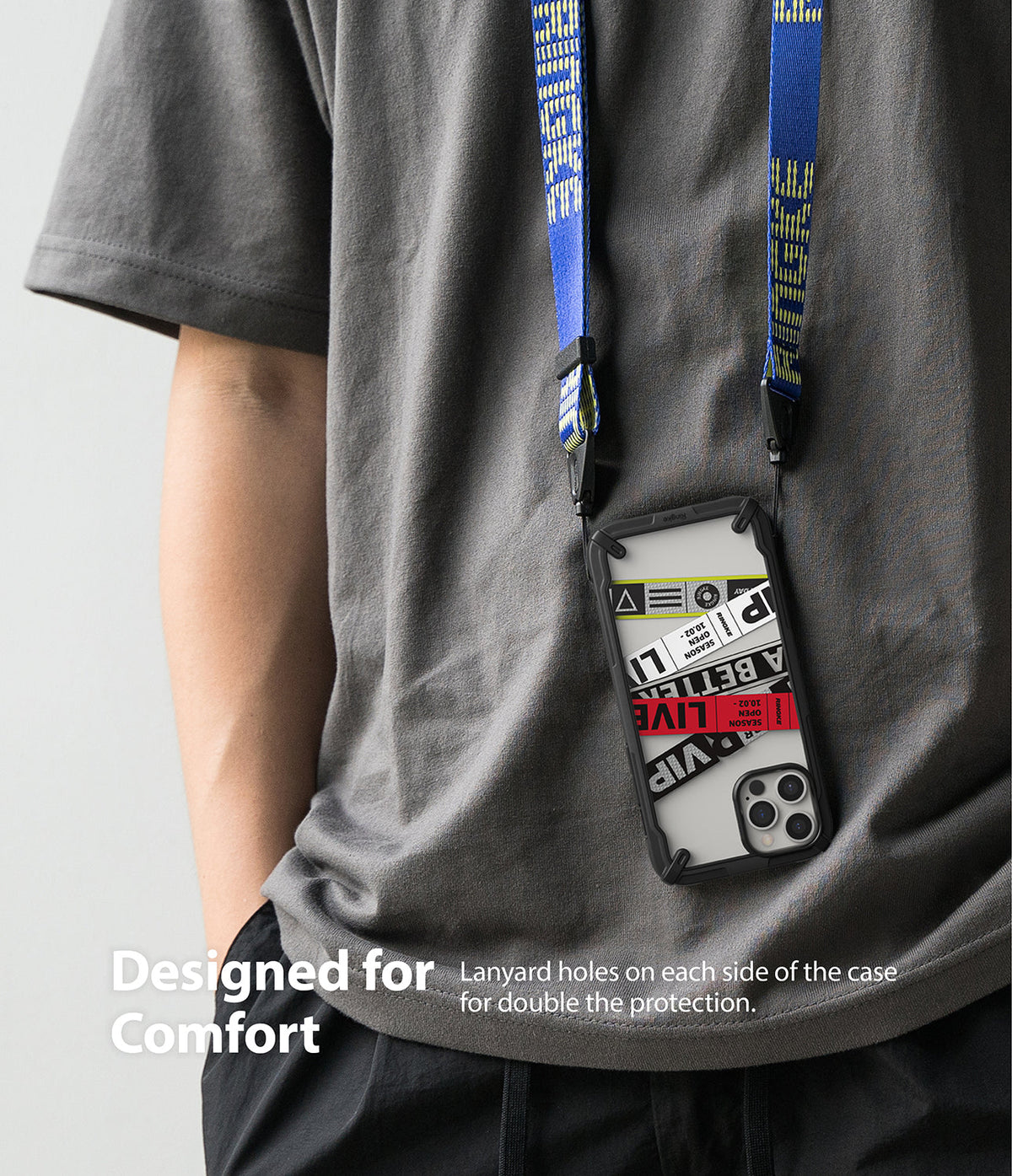 iPhone 12 Pro Max Case | Fusion-X Design - Person wearing a phone case with a blue lanyard and graphic sticker inserts.