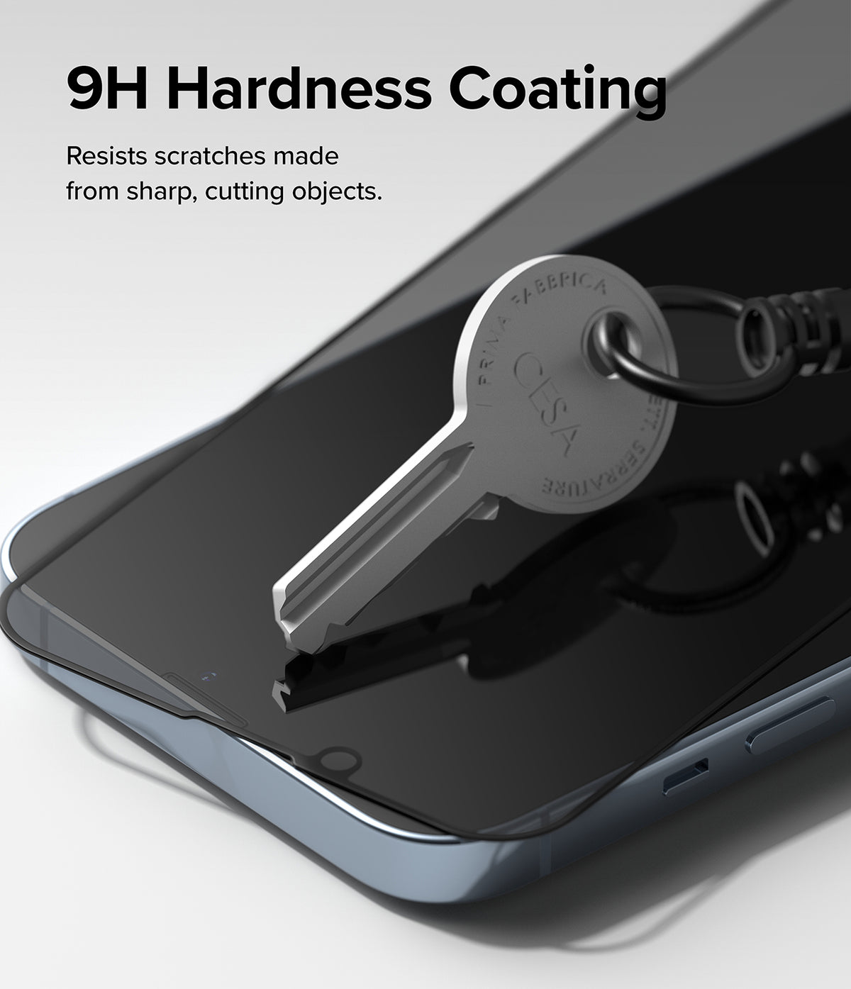 iPhone 14 Plus / 13 Pro Max Screen Protector | Privacy Glass - iPhone 14 Plus / 13 Pro Max Screen Protector - A metal key resting on a smartphone screen with a 9H hardness glass protector.