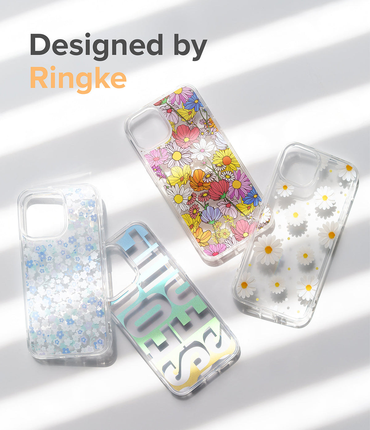 iPhone 13 Case | Fusion Design - Four clear iPhone 13 cases featuring floral, daisy, and holographic text patterns on a white background.