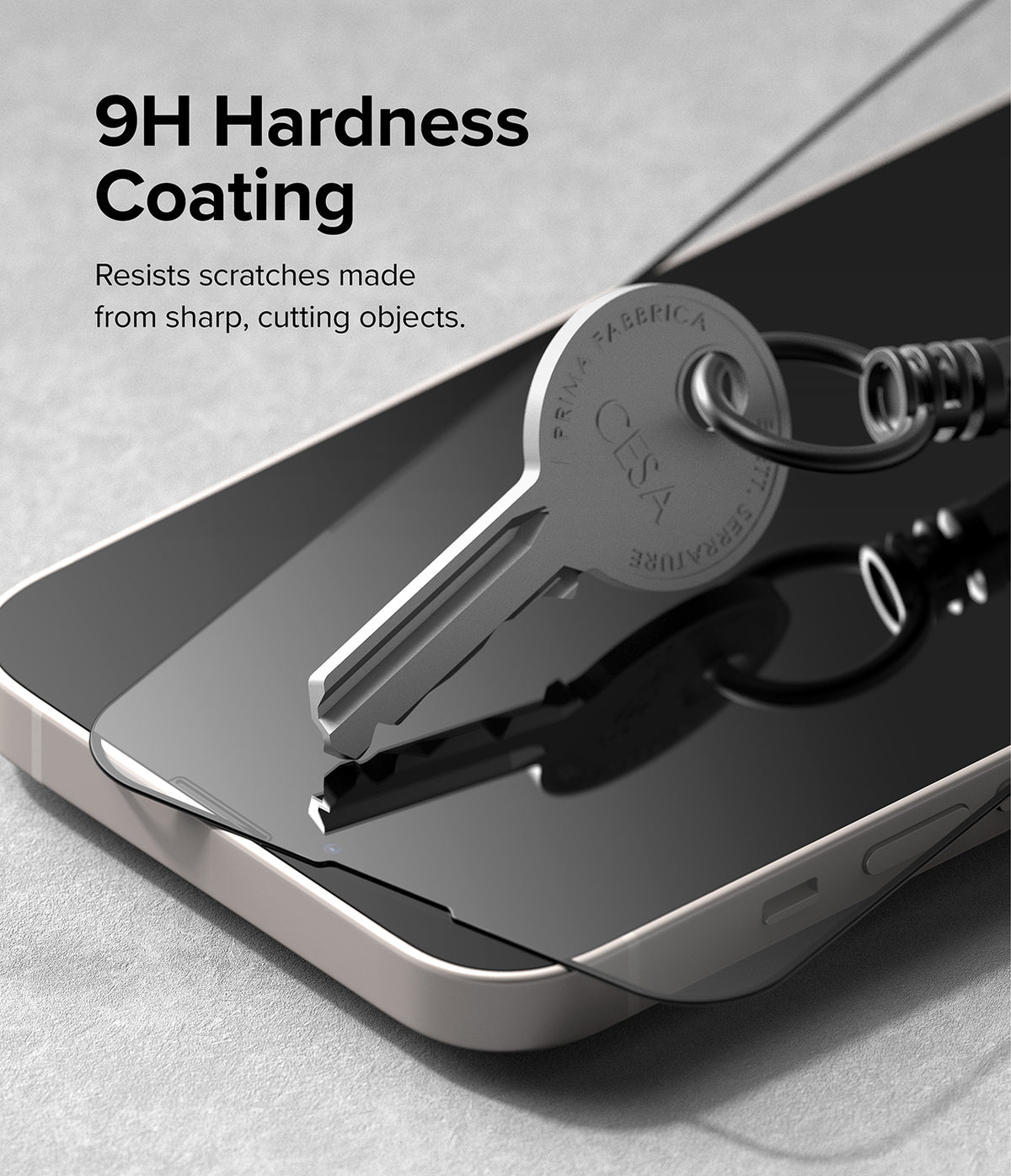 iPhone 14 Plus / 13 Pro Max Screen Protector | Full Cover Glass - iPhone 14 Plus / 13 Pro Max Screen Protector - A metal key resting on a phone screen protector to demonstrate scratch resistance.