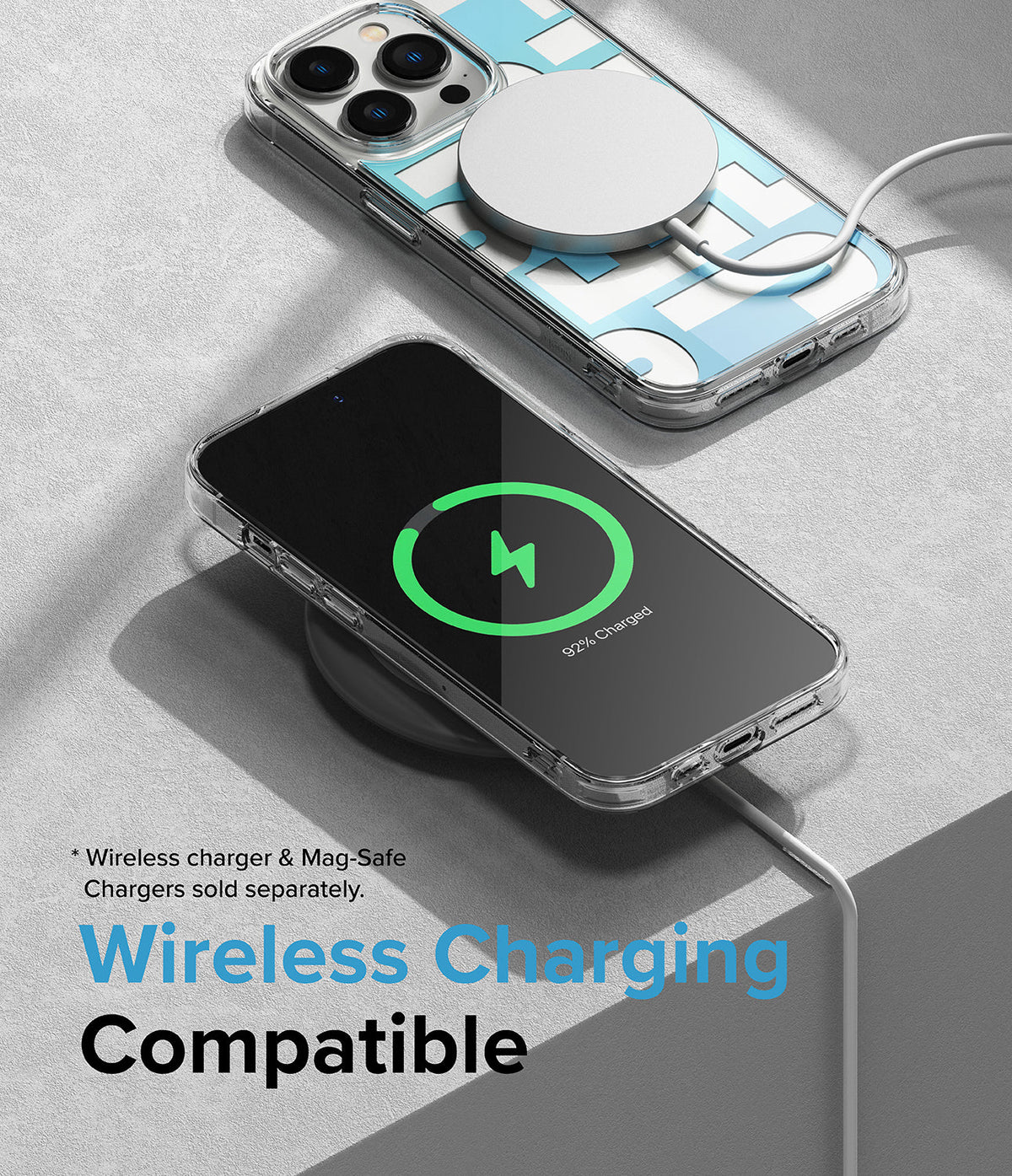 iPhone 14 Pro Max Case | Fusion Design - Clear phone case with blue geometric pattern charging wirelessly on a gray surface.
