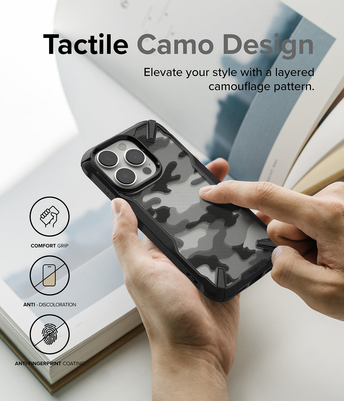 iPhone 14 Pro Max Case | Fusion-X - Hand holding a black phone case with a tactile, layered camouflage pattern.