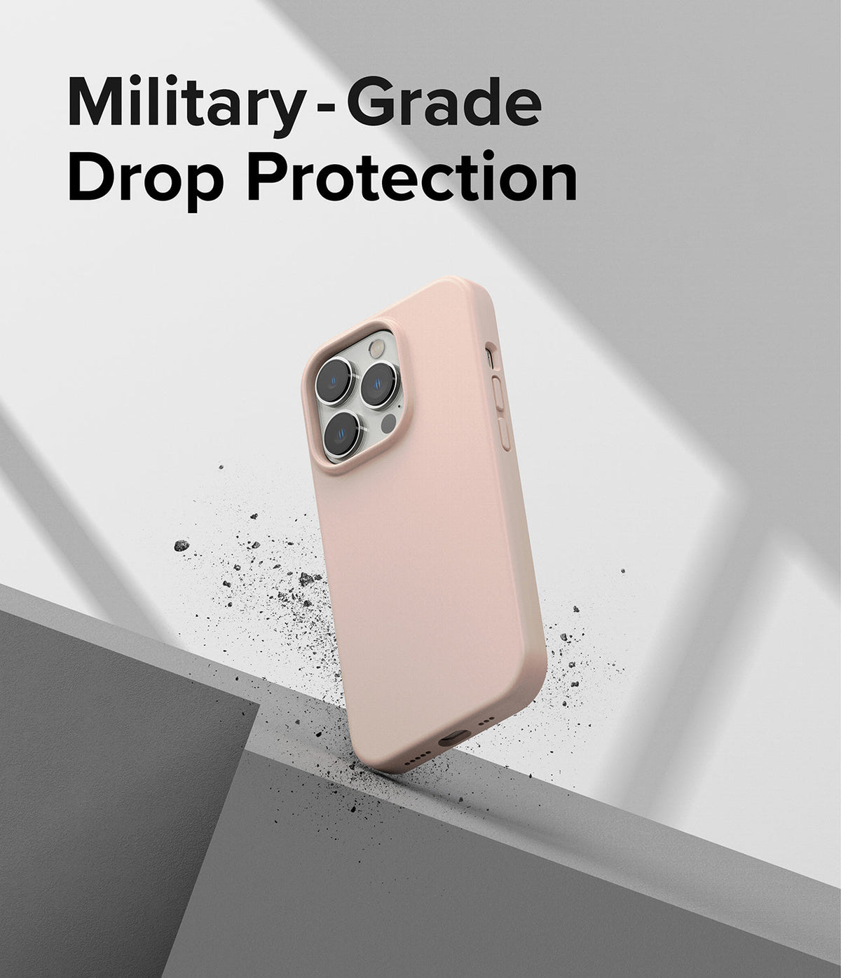 iPhone 14 Pro Max Case | Silicone - Pink silicone phone case floating above a gray surface with debris particles.