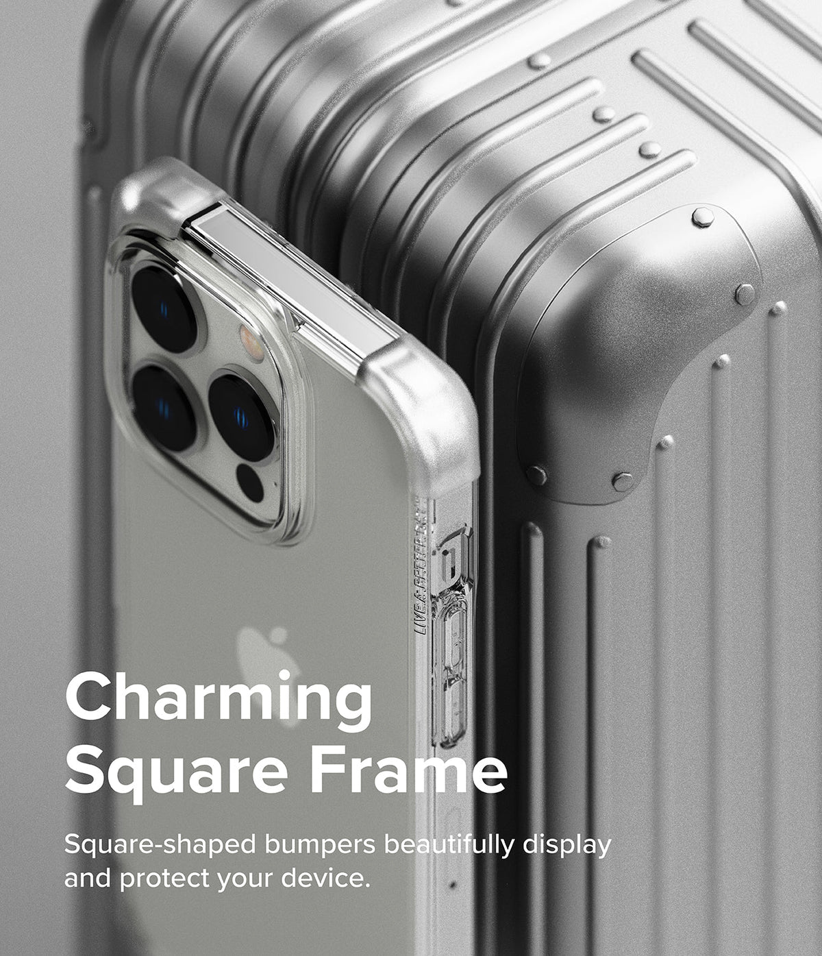 iPhone 14 Pro Case | Fusion Bumper - Clear square-frame bumper case on an iPhone 14 Pro resting against a metallic suitcase.
