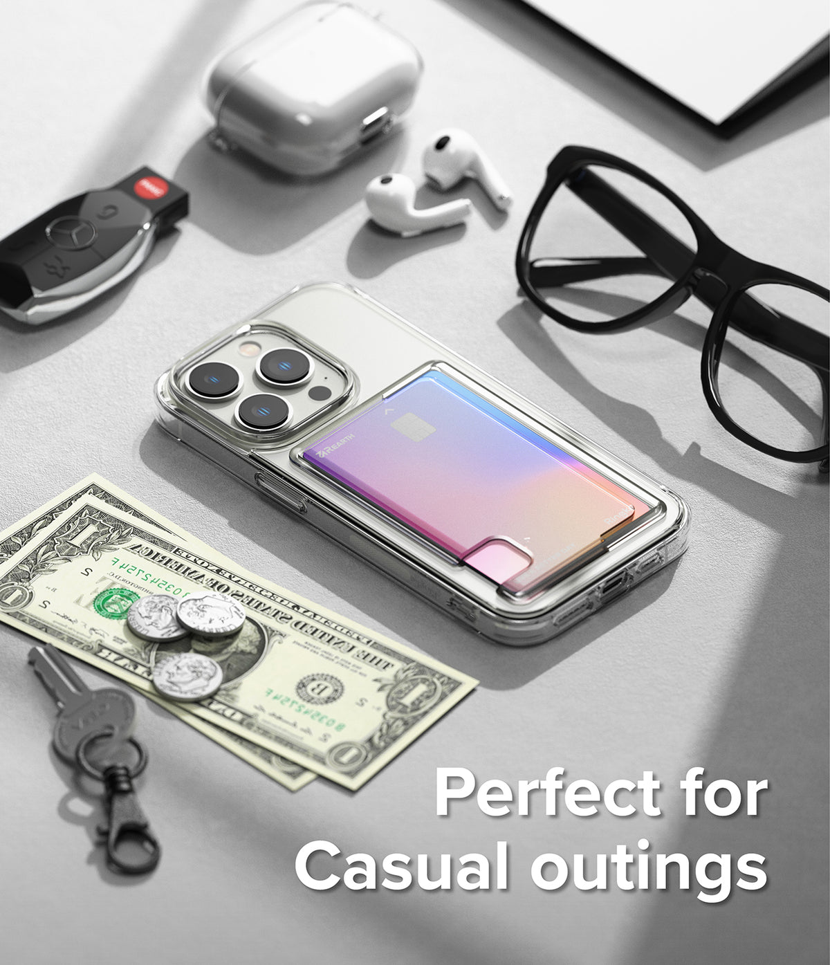 iPhone 14 Pro Case | Fusion Card - Clear phone case with iridescent card holder, surrounded by daily essentials on a desk.