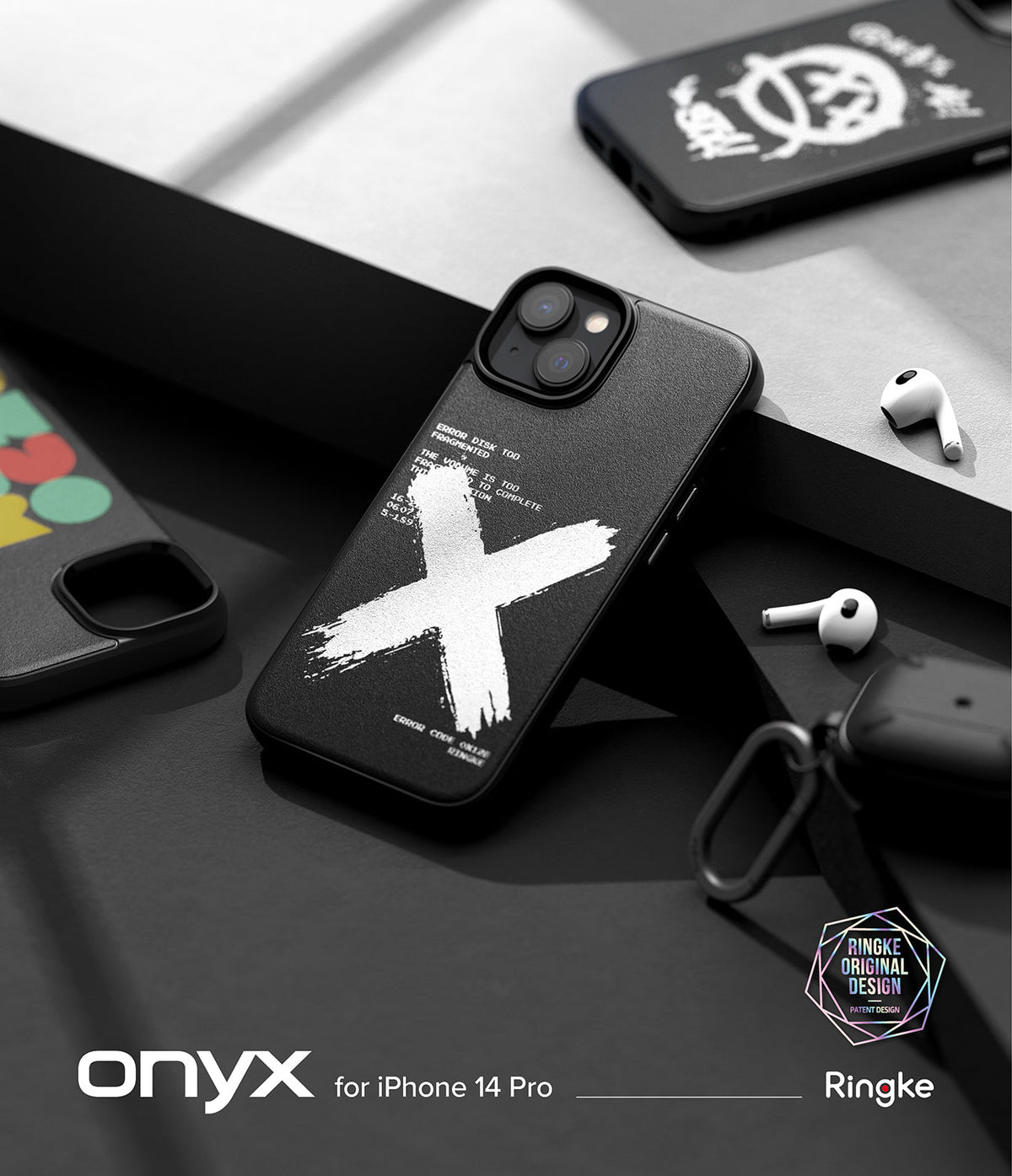 iPhone 14 Pro Case | Onyx Design - Black phone case with white brushstroke X and text, displayed with earbuds on a desk.