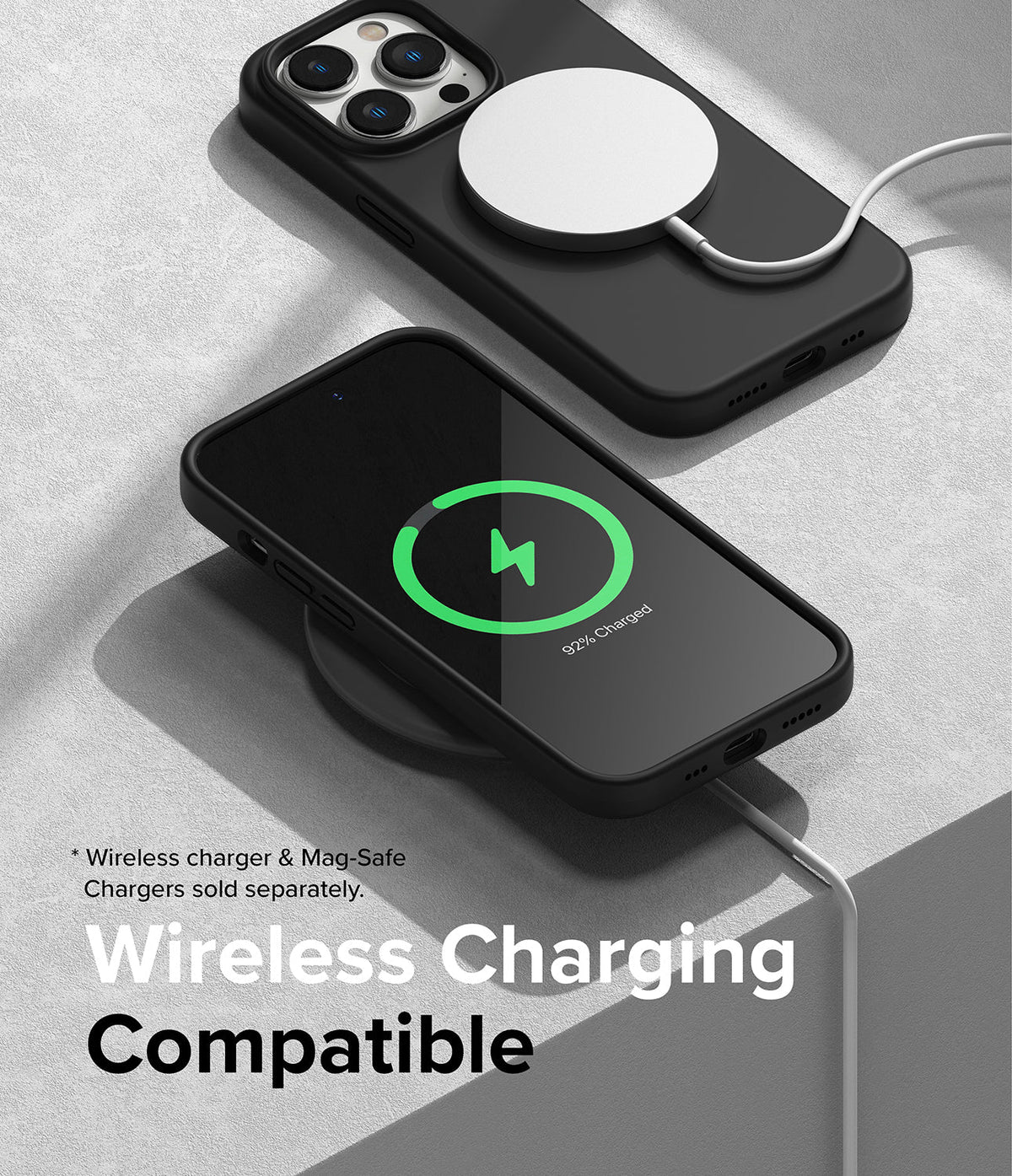 iPhone 14 Pro Case | Silicone - Black iPhone 14 Pro in a silicone case charging wirelessly with a MagSafe puck and charging pad.