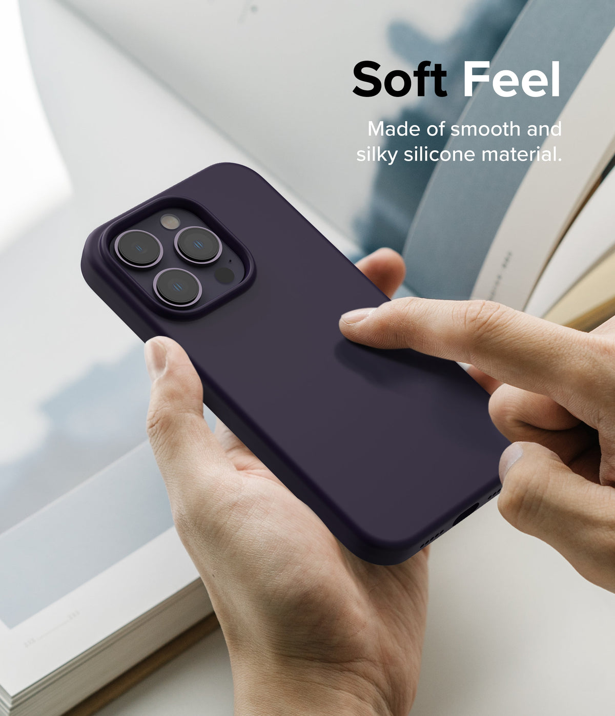 iPhone 14 Pro Case | Silicone - Hand holding a dark purple silicone iPhone 14 Pro case with text overlay Soft Feel.