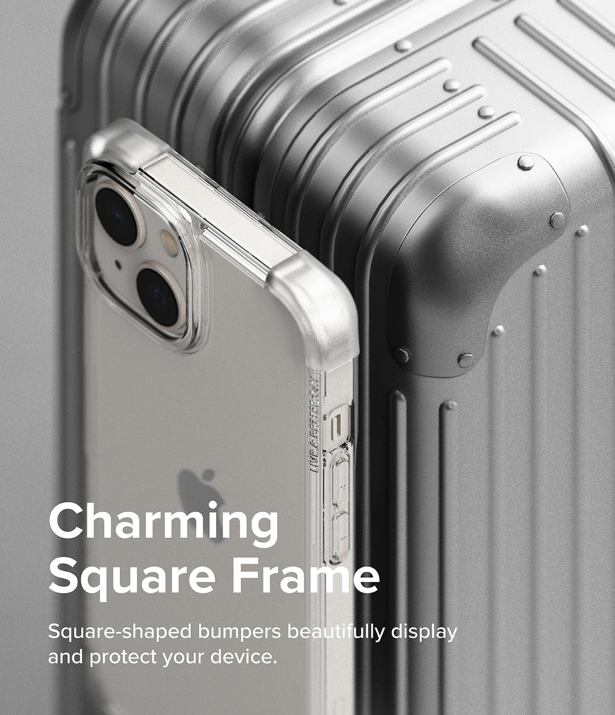 iPhone 14 Case | Fusion Bumper - Clear square-frame phone case resting against a metallic silver suitcase.