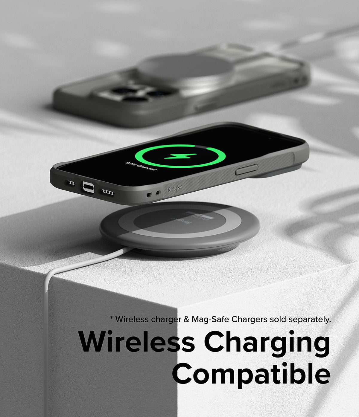 iPhone 15 Pro Max Case | Fusion Bold - iPhone 15 Pro Max in a grey case wirelessly charging on a circular pad.