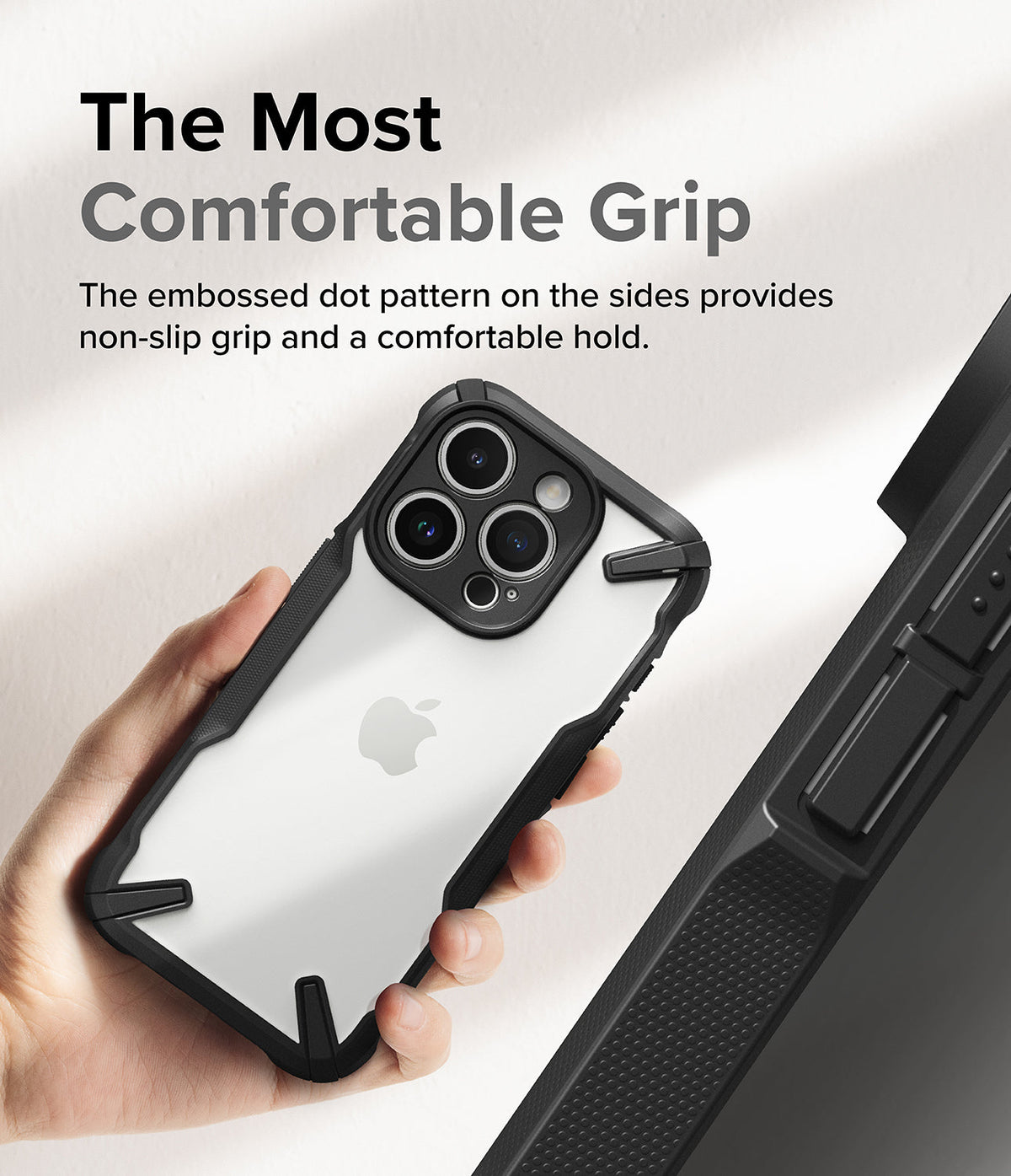 iPhone 15 Pro Max Case | Fusion-X - Hand holding a phone in a black protective case with a textured, non-slip dot pattern.