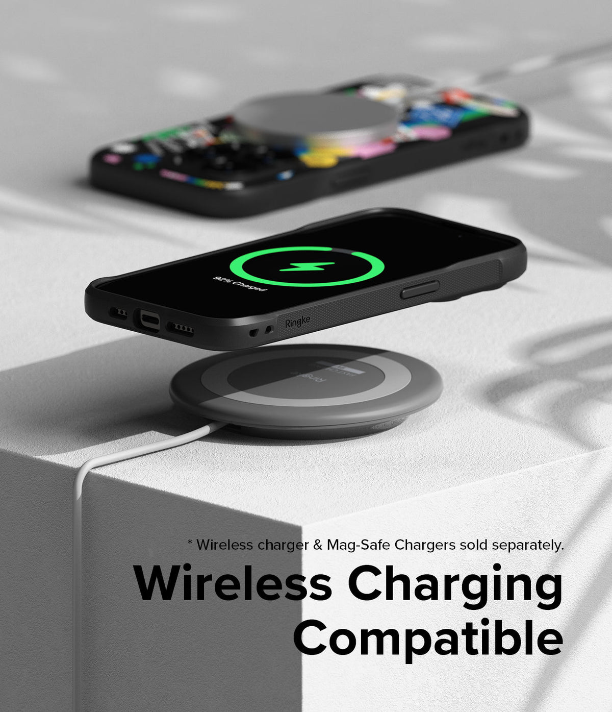 iPhone 15 Pro Max Case | Onyx Design - Black phone case hovering over a wireless charging pad showing a charging icon.