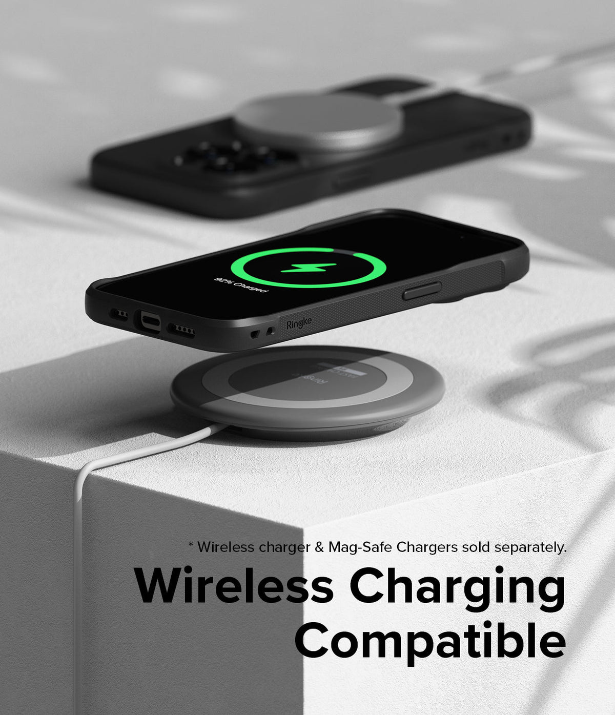 iPhone 15 Pro Max Case | Onyx Magnetic - Black phone case hovering over a wireless charger with a green charging icon.