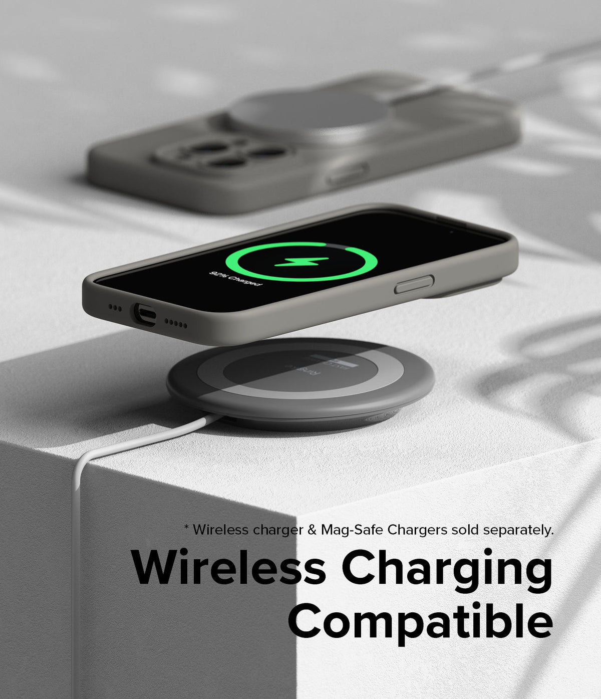 iPhone 15 Pro Max Case | Silicone Magnetic - Gray phone case on a wireless charging pad showing a charging icon.