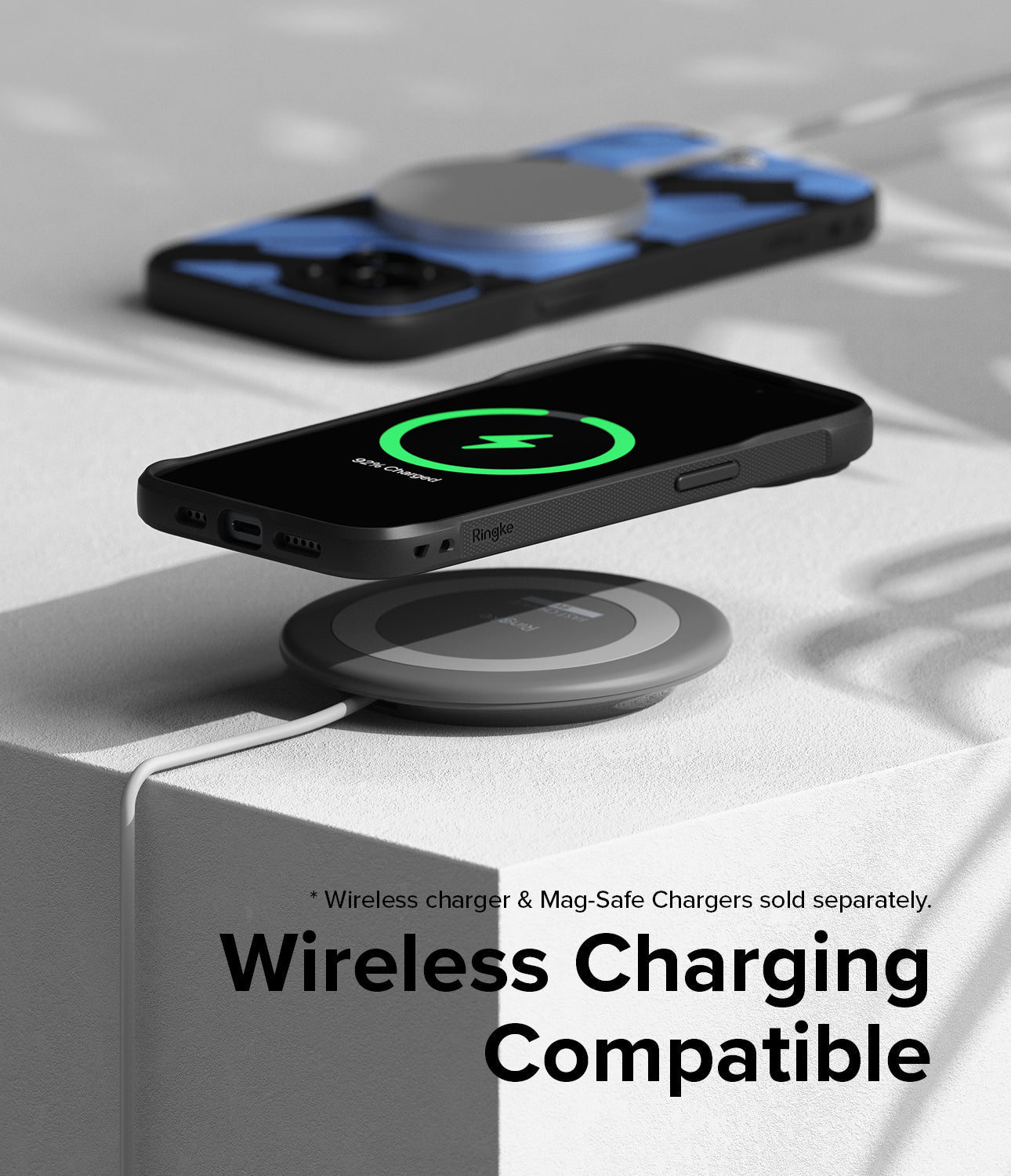 iPhone 15 Plus Case | Onyx Design - iPhone 15 Plus in a black case hovering over a wireless charging pad showing a green icon.