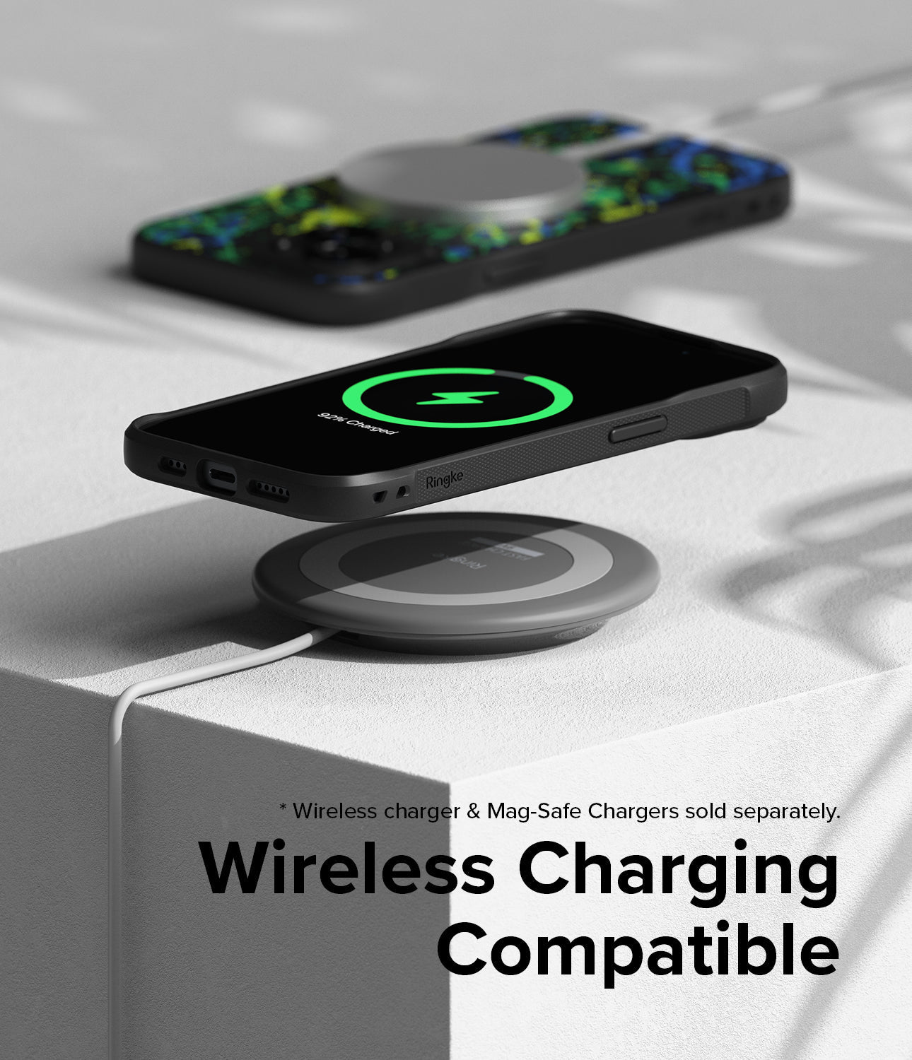 iPhone 15 Plus Case | Onyx Design - iPhone 15 Plus in an Onyx case wirelessly charging on a circular pad.