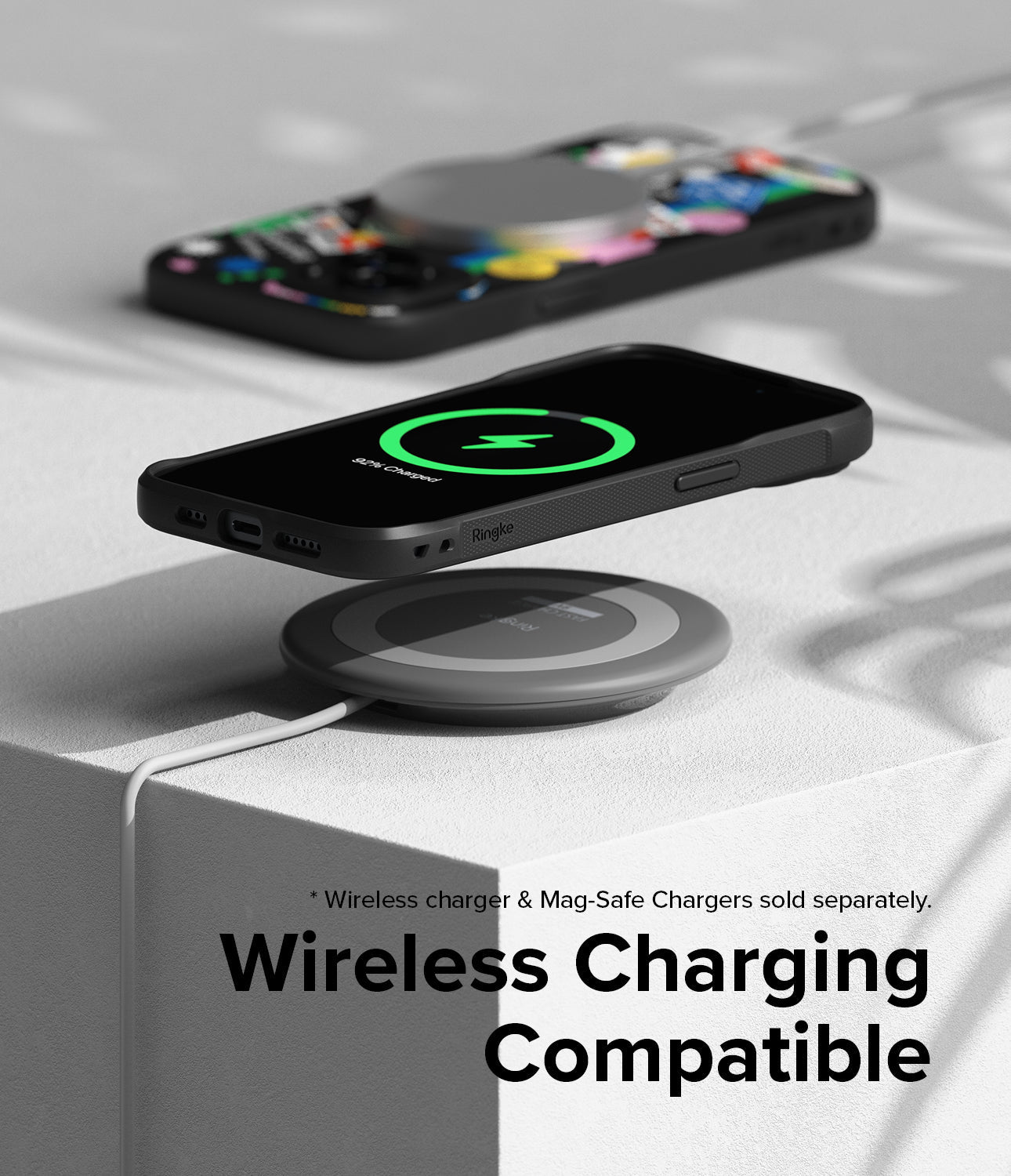 iPhone 15 Plus Case | Onyx Design - Black phone case on a wireless charging pad showing a green charging icon on screen.