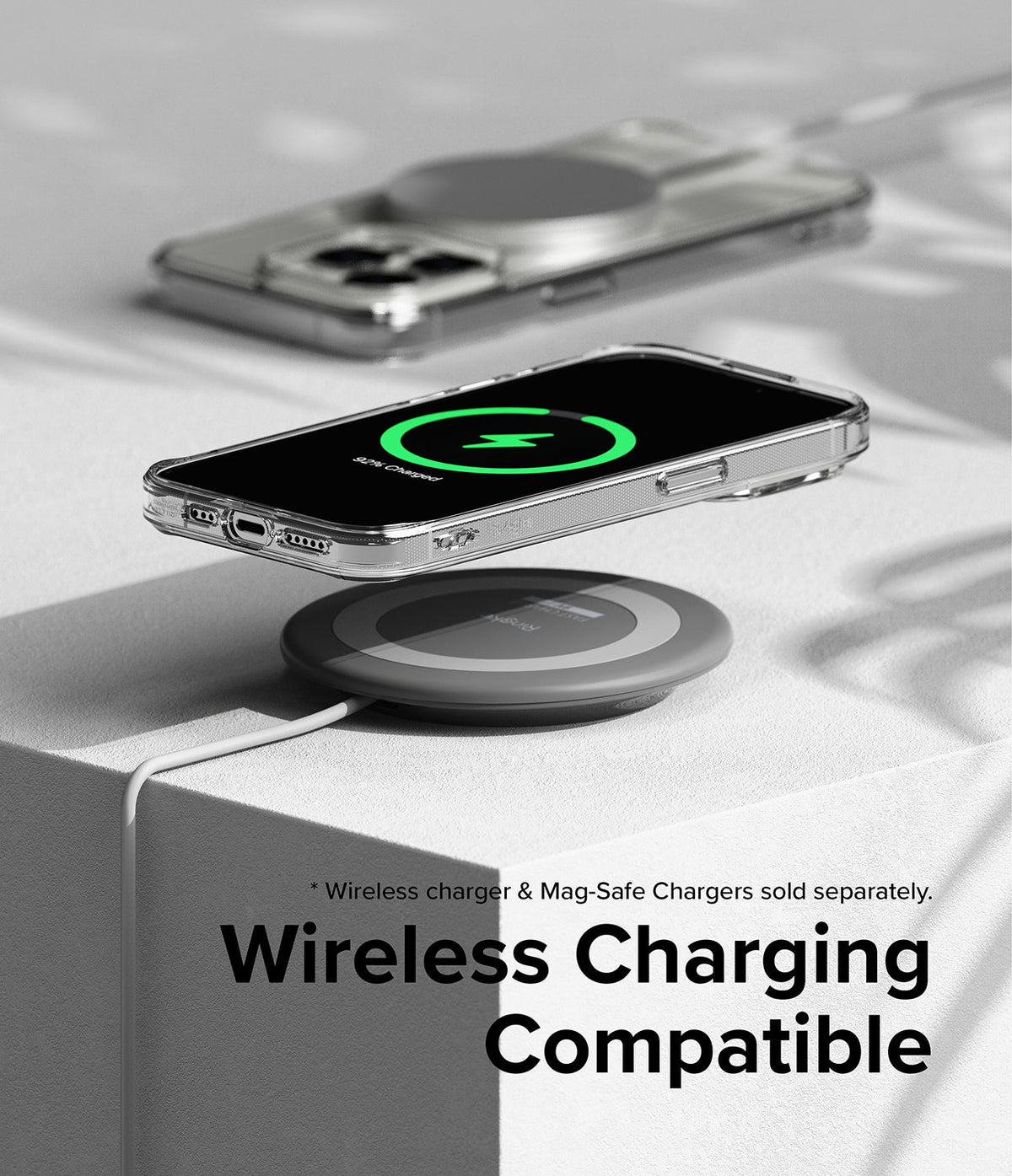 iPhone 15 Pro Case | Fusion Magnetic - Clear phone case hovering over a wireless charging pad showing a charging icon.