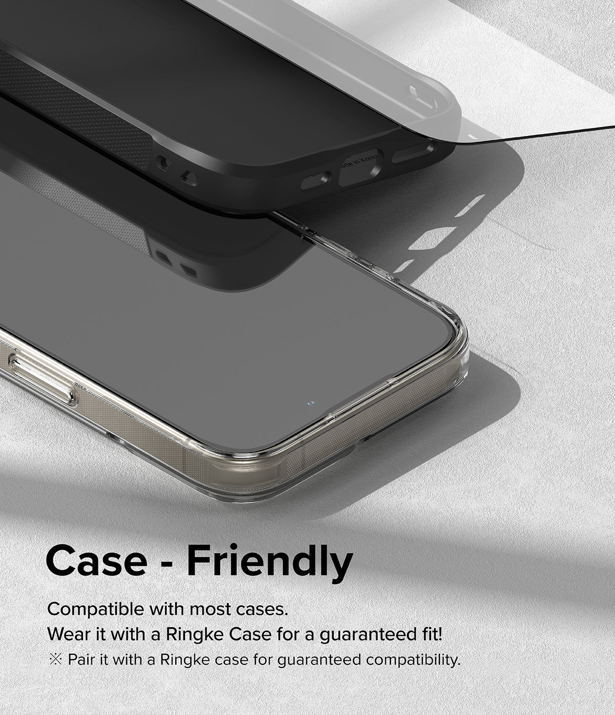 iPhone 15 Pro Screen Protector | Easy Slide Tempered Glass - iPhone 15 Pro Screen Protector - Tempered glass screen protector hovering above an iPhone 15 Pro inside a protective case.