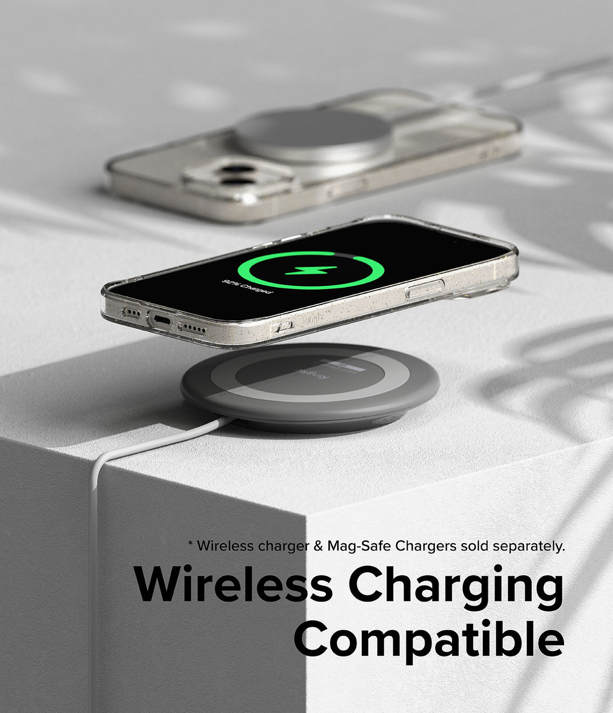 iPhone 15 Case | Air - Clear phone case on a wireless charging pad showing a green charging icon on the screen.