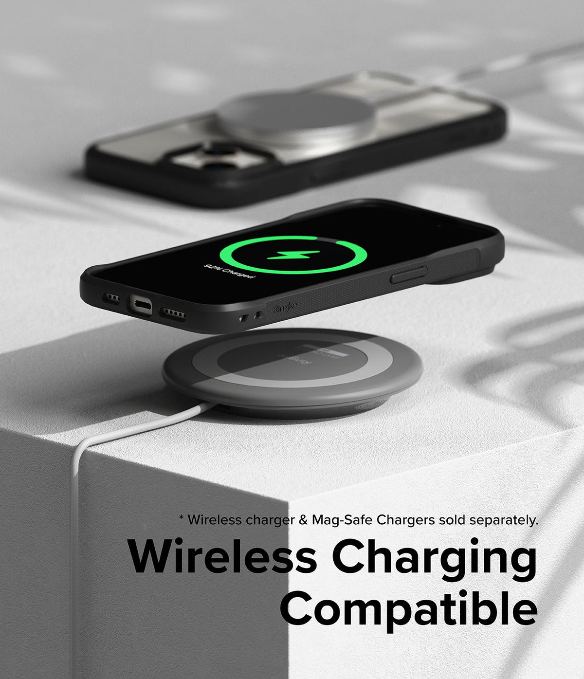 iPhone 15 Case | Fusion Bold - Black phone case on a wireless charging pad showing a green charging icon on the screen.