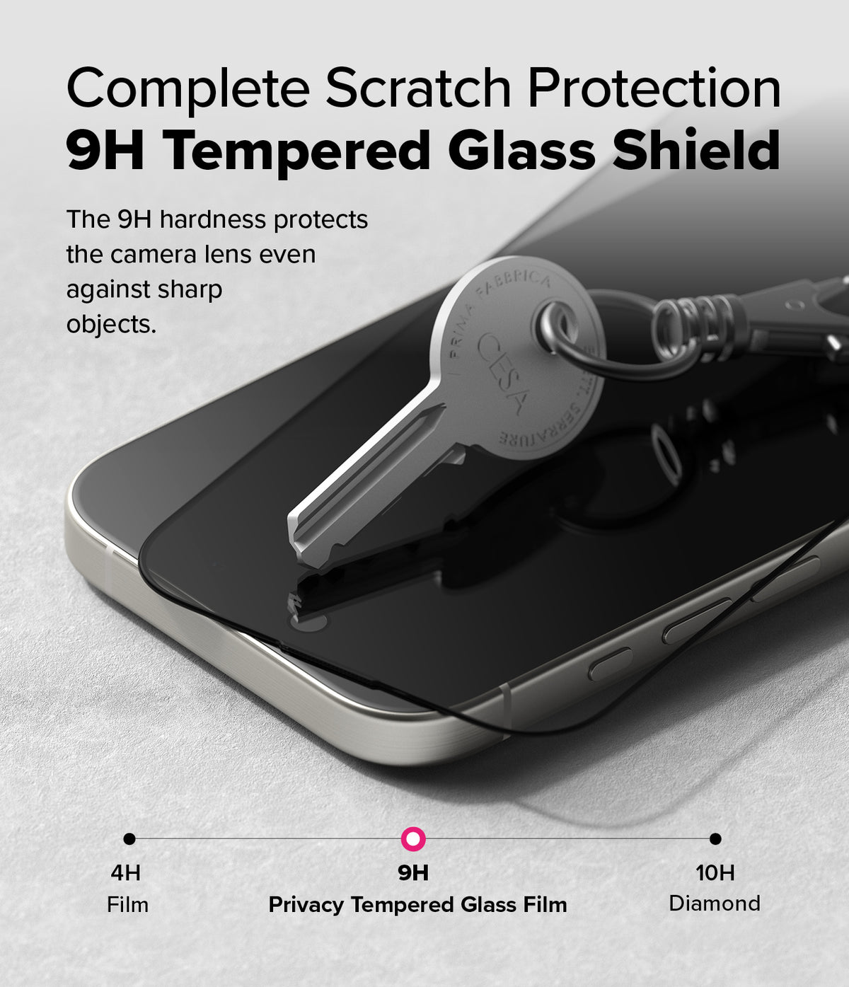 iPhone 16 Pro Screen Protector | Easy Slide Privacy Tempered Glass - iPhone 16 Pro Screen Protector - A metal key resting on a 9H tempered glass screen protector atop an iPhone 16 Pro.