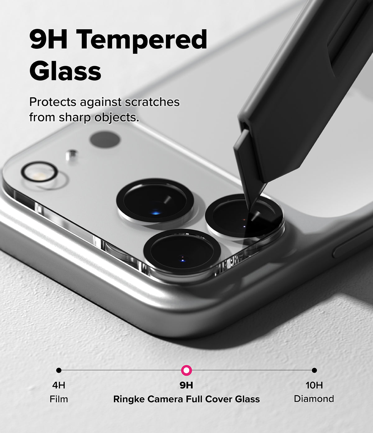 iPhone 17 Pro Max | Camera Glass - A utility knife blade presses against a 9H tempered glass camera lens protector on a phone.