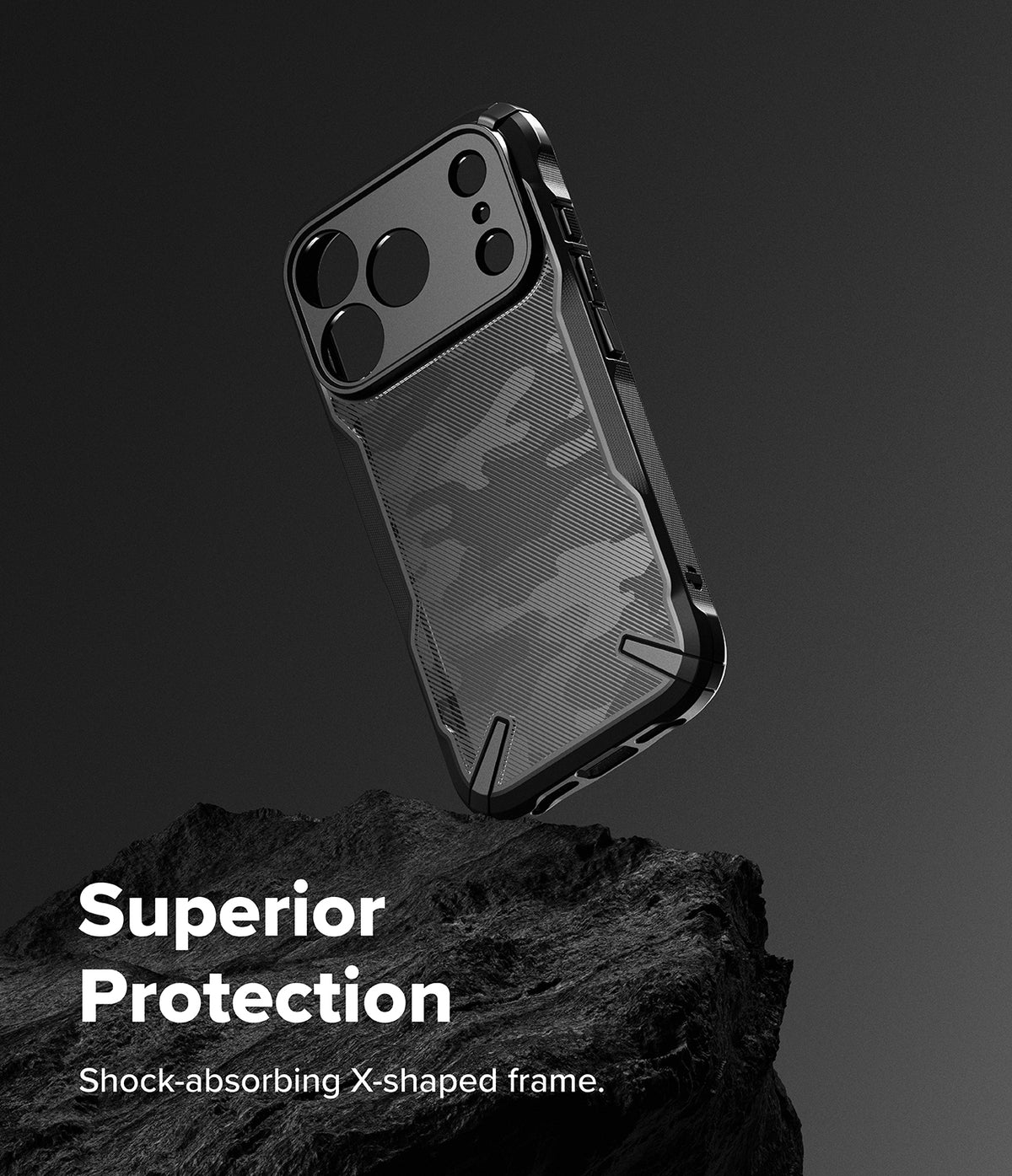 iPhone 17 Pro Max Case | Fusion-X - Black camouflage phone case with a rugged X-shaped frame resting on a dark rock.