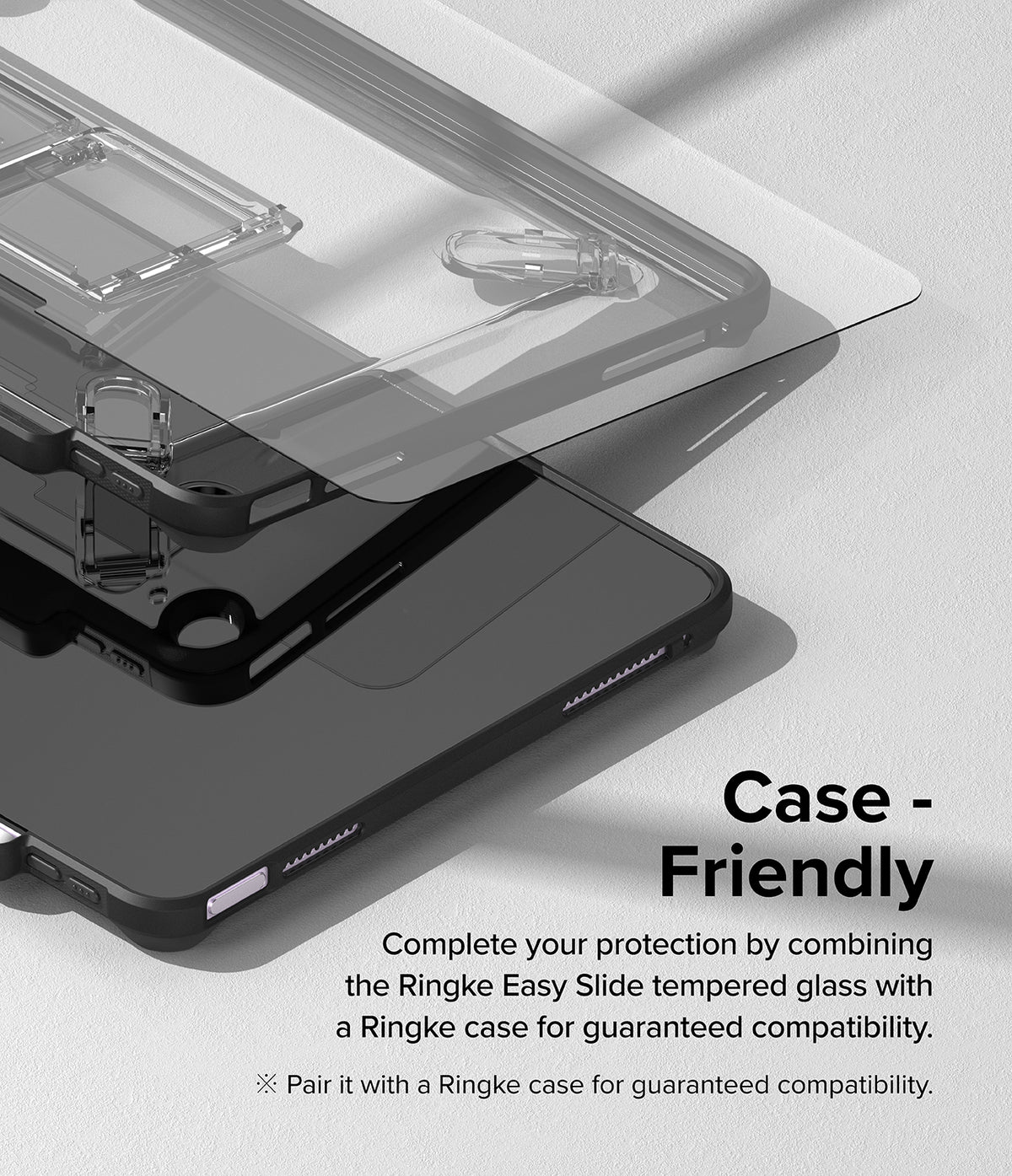Easy Slide Tempered Glass | iPad - Tempered glass screen protector hovering above an iPad inside a protective case.