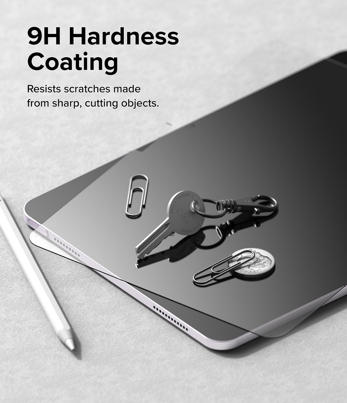Easy Slide Tempered Glass | iPad - iPad screen with 9H hardness coating, featuring a key, coin, and paperclips on surface.