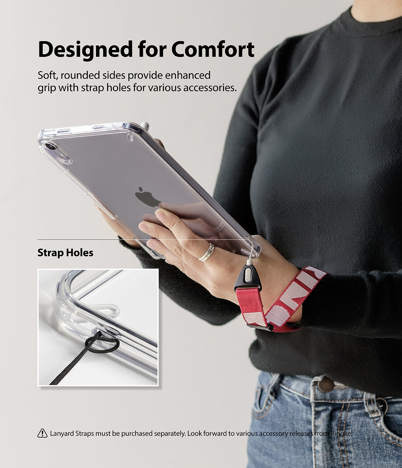 Fusion | iPad - Person holding a clear iPad case with a red lanyard strap attached to the integrated corner strap holes.
