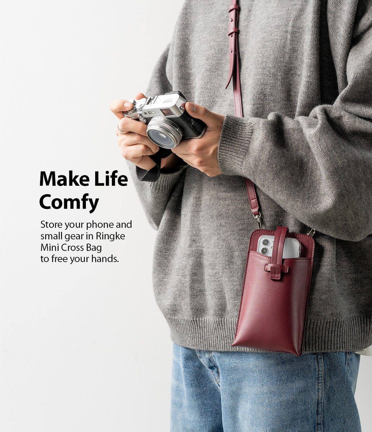 Mini Cross Bag | PU Leather - Person wearing a burgundy PU leather crossbody phone bag while holding a camera.