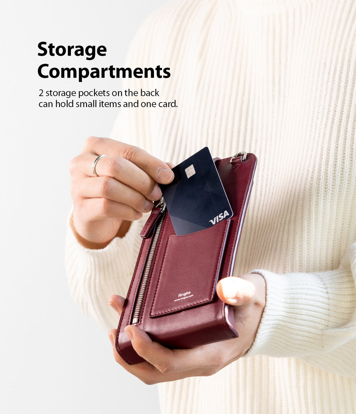 Mini Cross Bag | PU Leather - Mini Cross Bag - Person inserting a credit card into the back pocket of a burgundy PU leather mini crossbody bag.