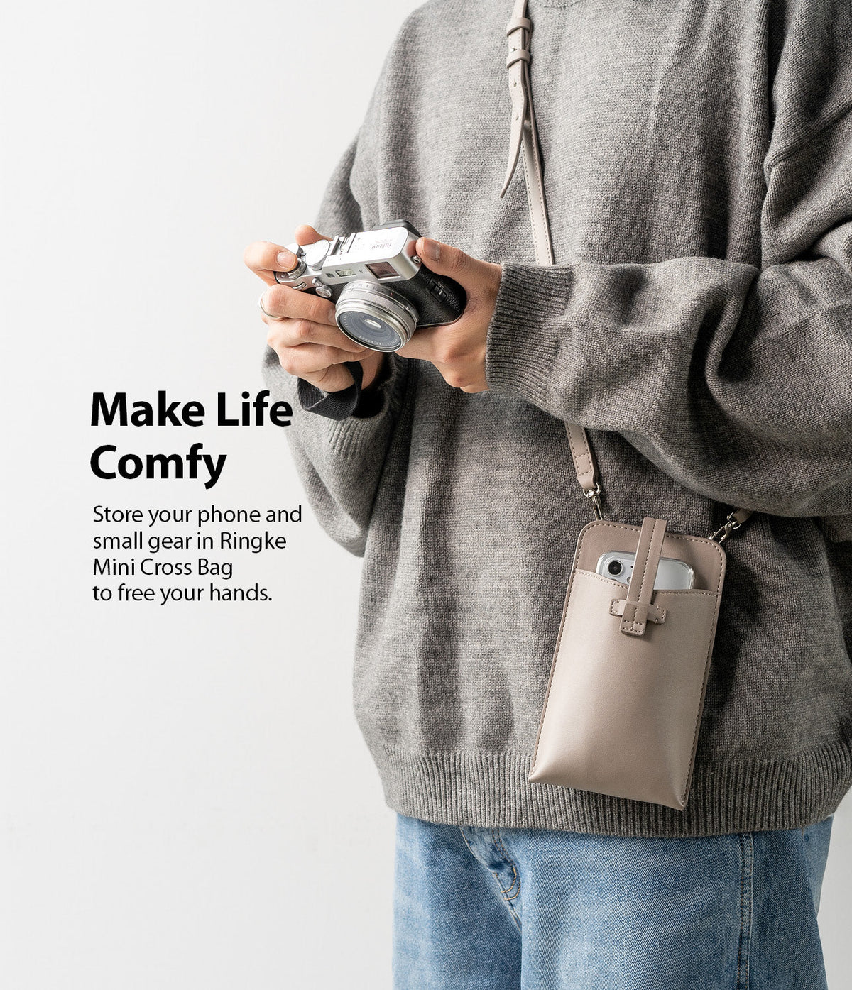 Mini Cross Bag | PU Leather - Person wearing a beige PU leather crossbody phone bag while holding a vintage camera.