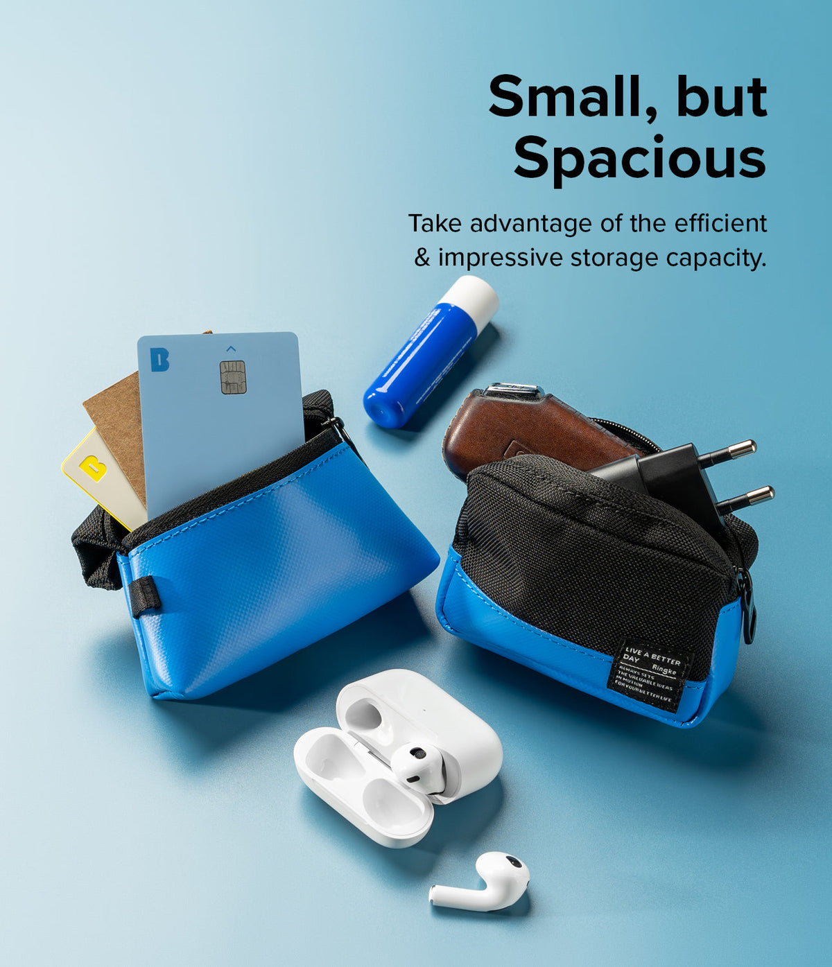 Mini Pouch Tarpaulin | Roll Top - Two small blue pouches filled with cards, a charger, and earbuds on a blue background.
