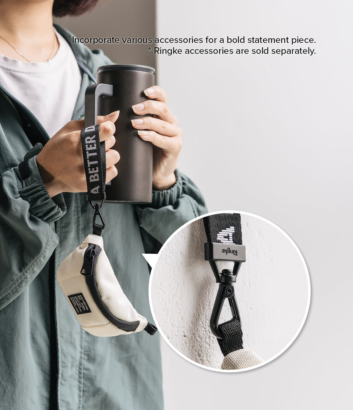 Mini Pouch | Sling Bag - A person holding a tumbler with a small beige pouch attached to the handle via a branded strap.