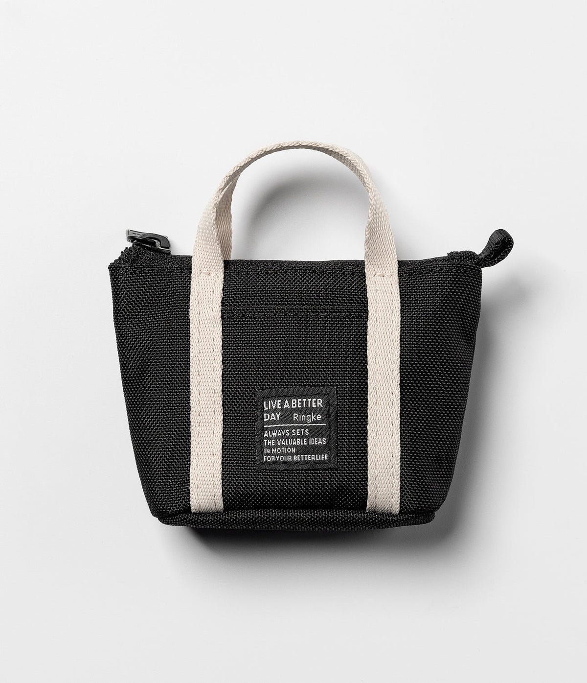 Mini Pouch | Tote Bag - Black mini tote bag with beige handles and a square branded patch on a light gray background.