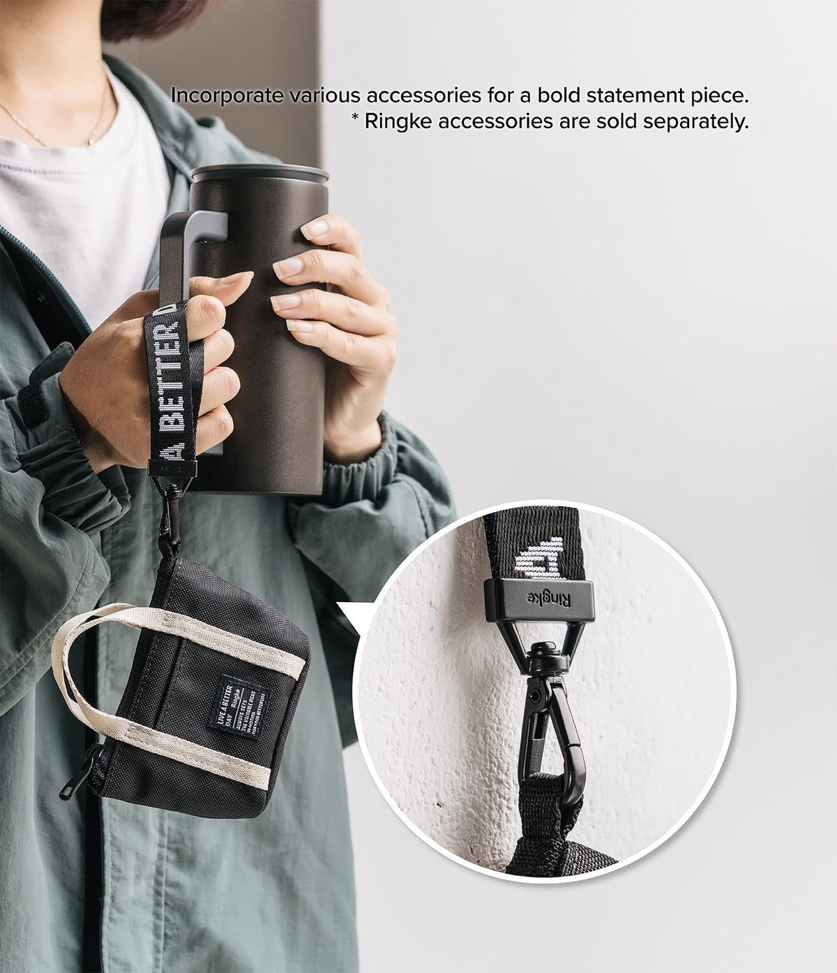 Mini Pouch | Tote Bag - A person holds a black tumbler with a branded strap attached to a small black tote pouch.