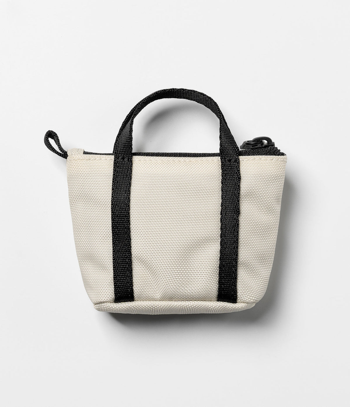 Mini Pouch | Tote Bag - A small, off-white canvas pouch with black handles and a top zipper, shaped like a miniature tote.